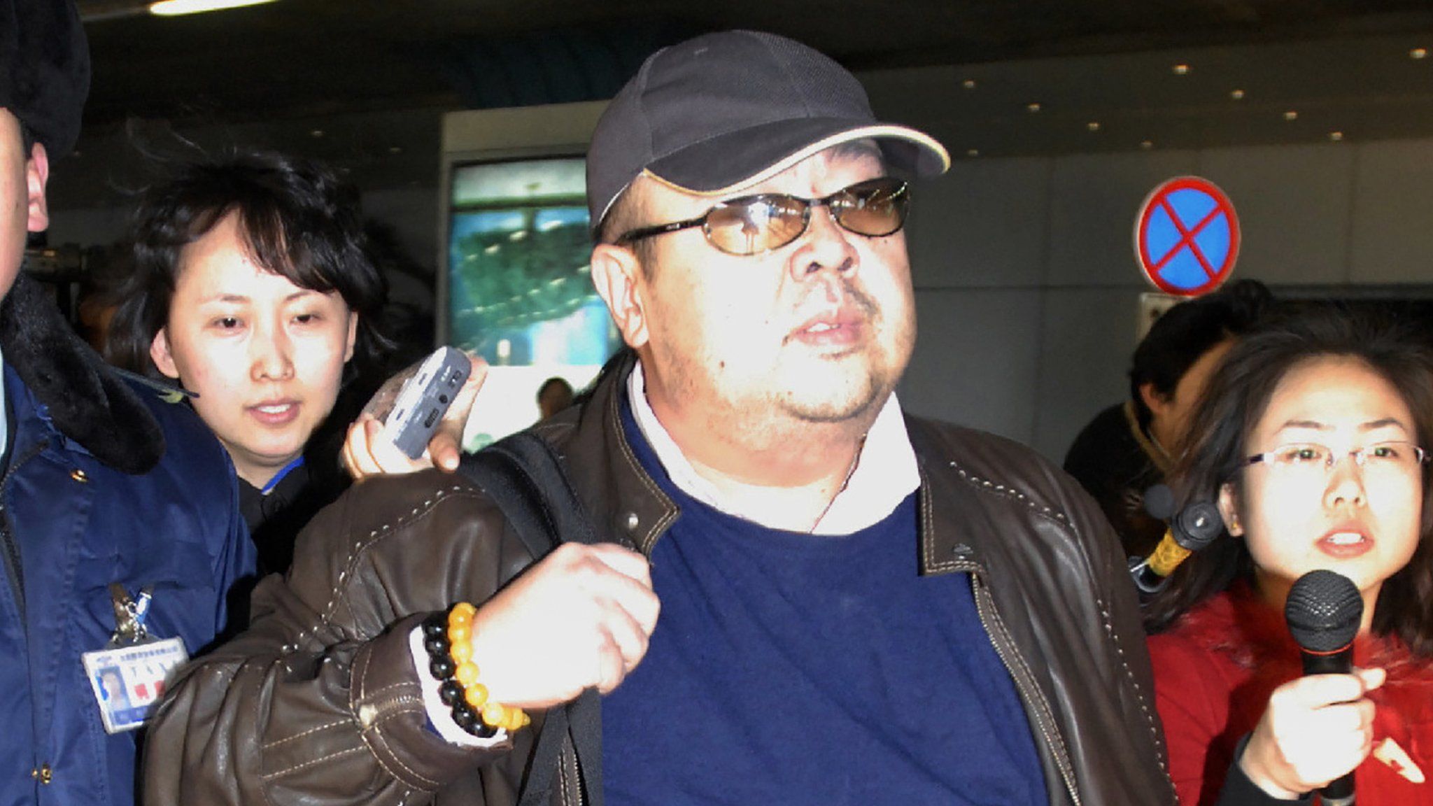 This photo taken on February 11, 2007 shows a man believed to be then-North Korean leader Kim Jong-Il's eldest son, Kim Jong-Nam (C), walking amongst journalists upon his arrival at Beijing's international airport