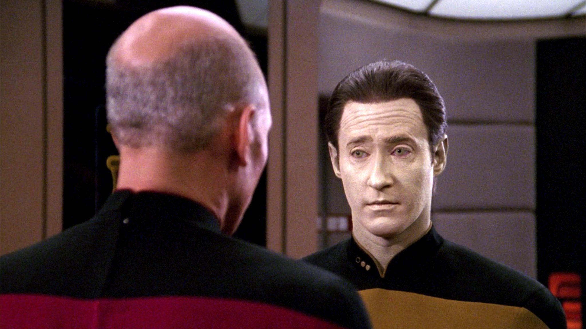 A picture of Star Trek's Capt Jean-Luc Picard speaking with android character Data