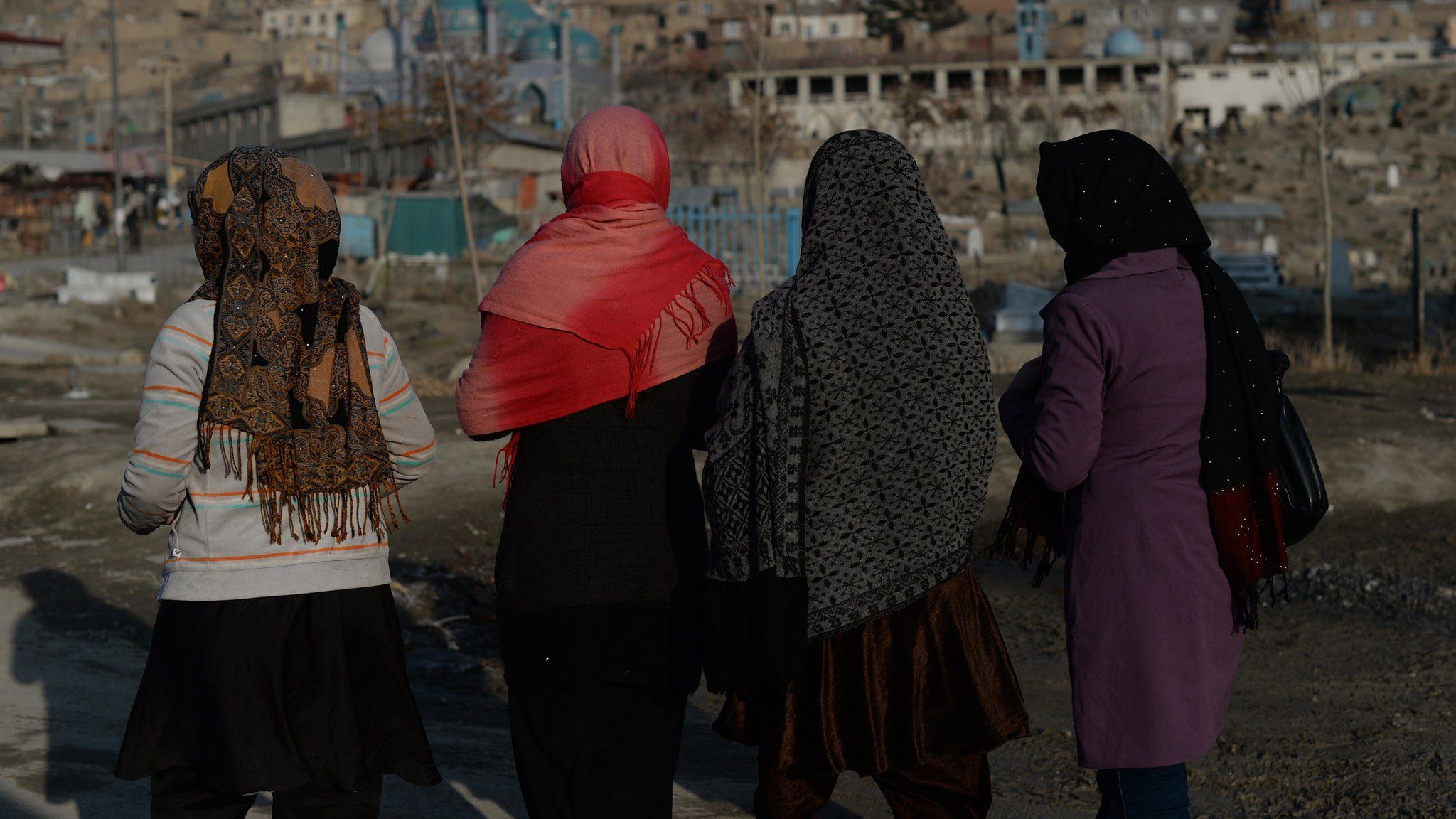 Afghan pedestrians make their way along a street in downtown Kabul on January 14, 2014