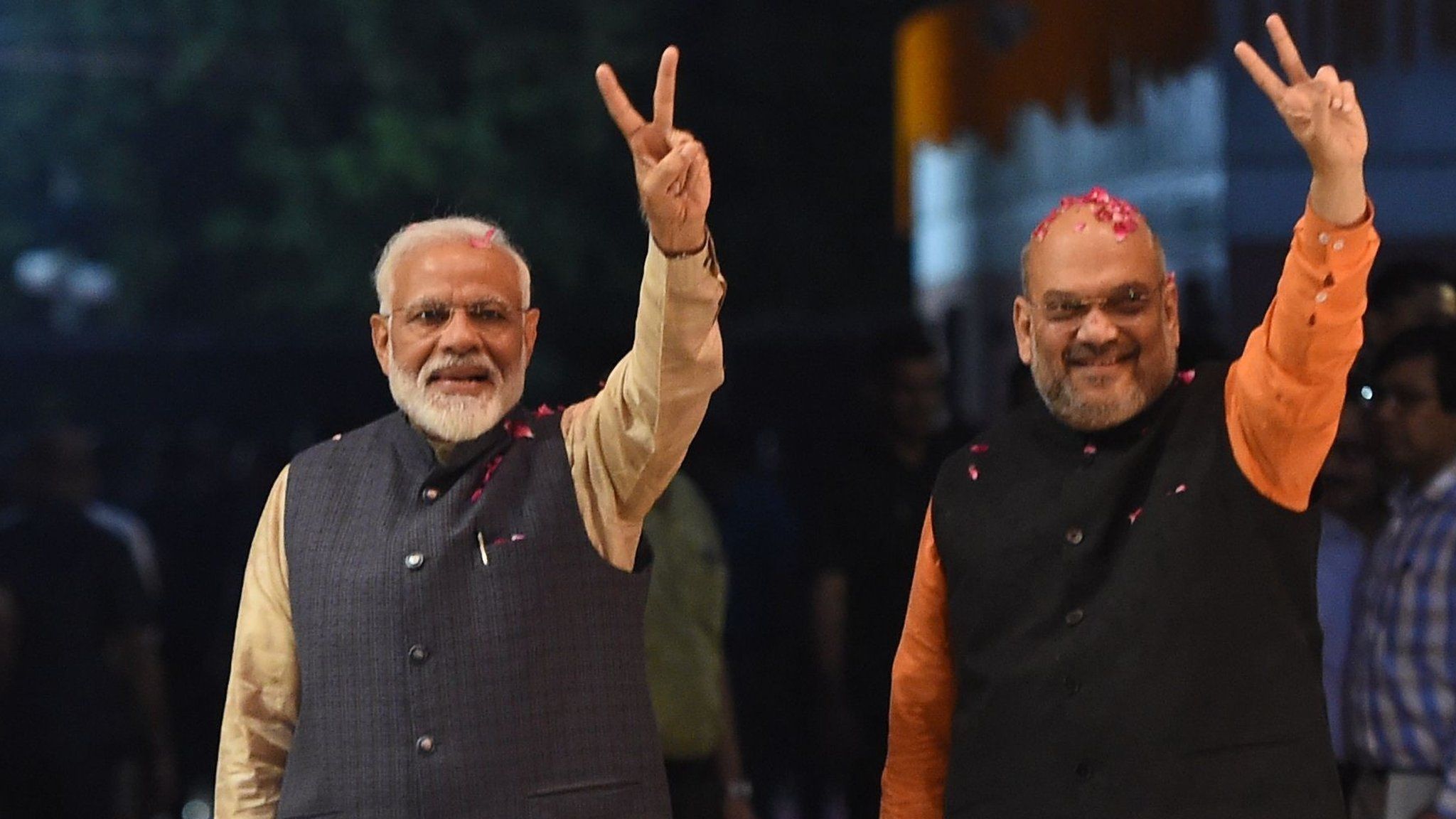 Indian Prime Minister Narendra Modi (L) and president of the ruling Bharatiya Janata Party (BJP) Amit Shah gesture as they celebrate the victory in India"s general elections, in New Delhi on May 23, 2019.