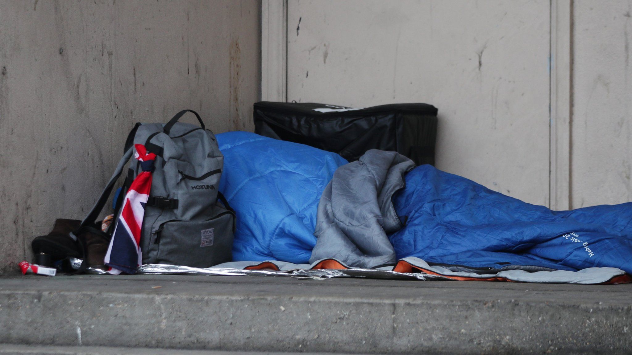 A homeless person in a sleeping bag on the streets in the UK