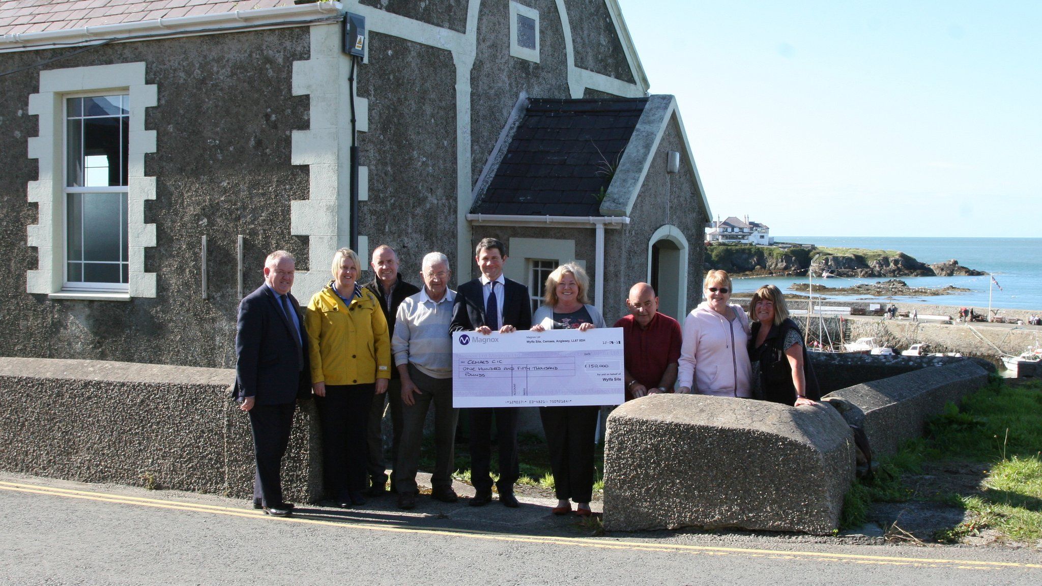 Cemaes CIC receiving a cheque worth £150,000 from the Magnox Socio-Economic Scheme