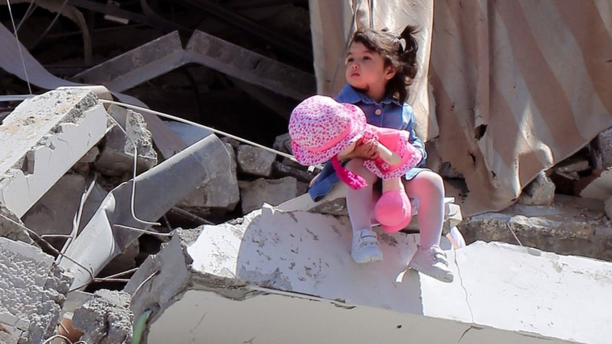 Celine by Shaban El Sousi - a photo showing a two-year-old Palestinian girl sitting on the ruins of a tower block in Gaza in May 2021
