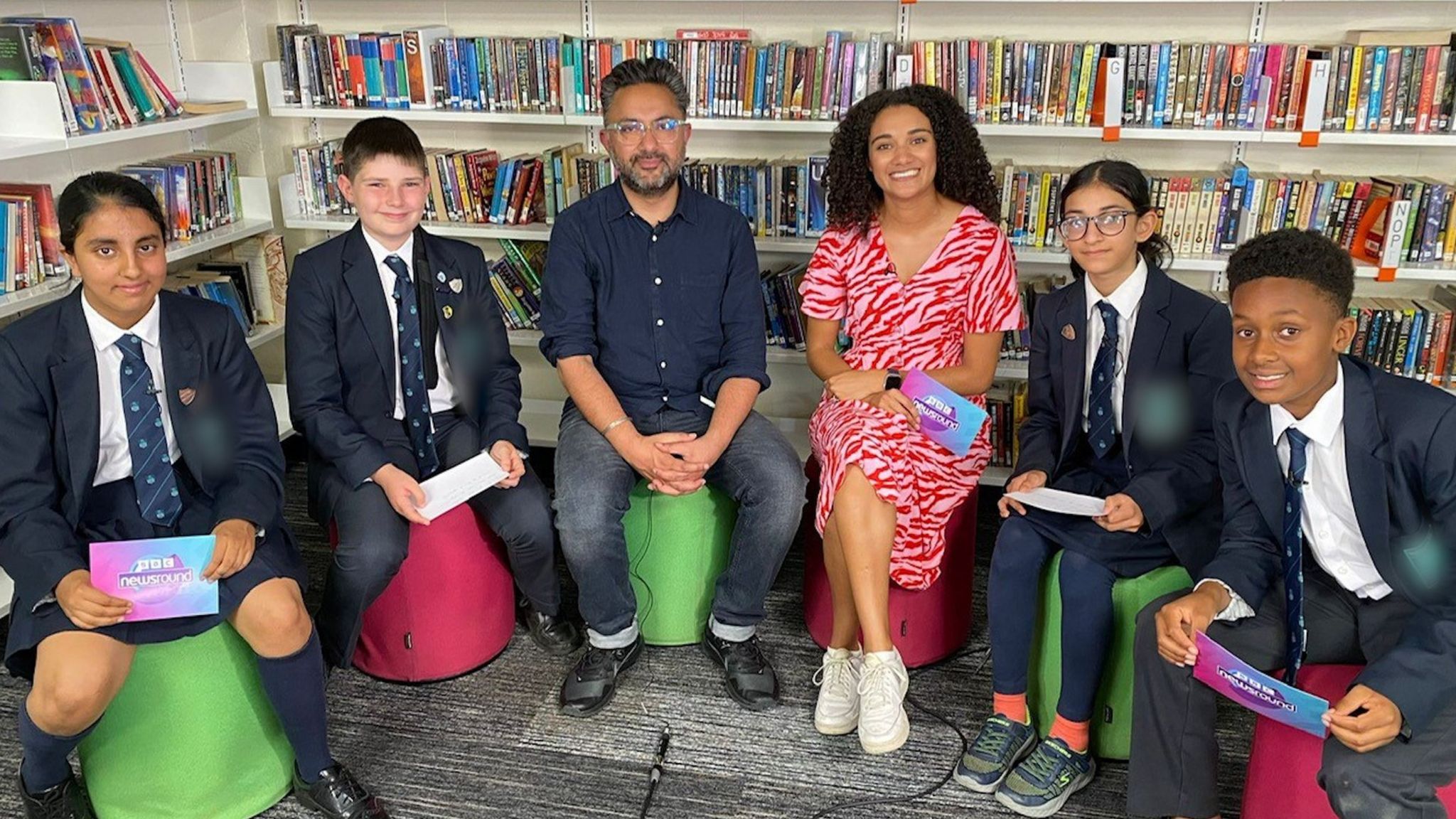 Author and journalist Sathnam Sanghera and Newsround presenter Nina Blissett with four school children.