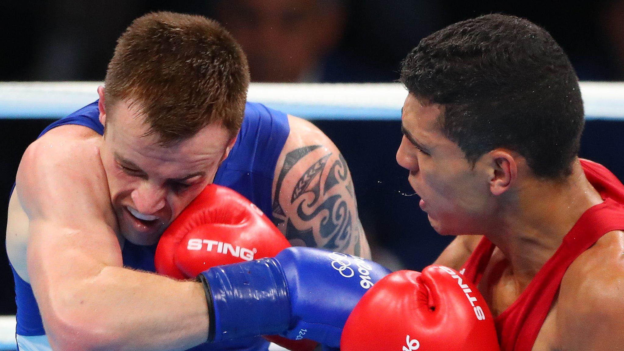 World champion Mohammed Rabii lands a right on Steven Donnelly during the Olympic quarter-final