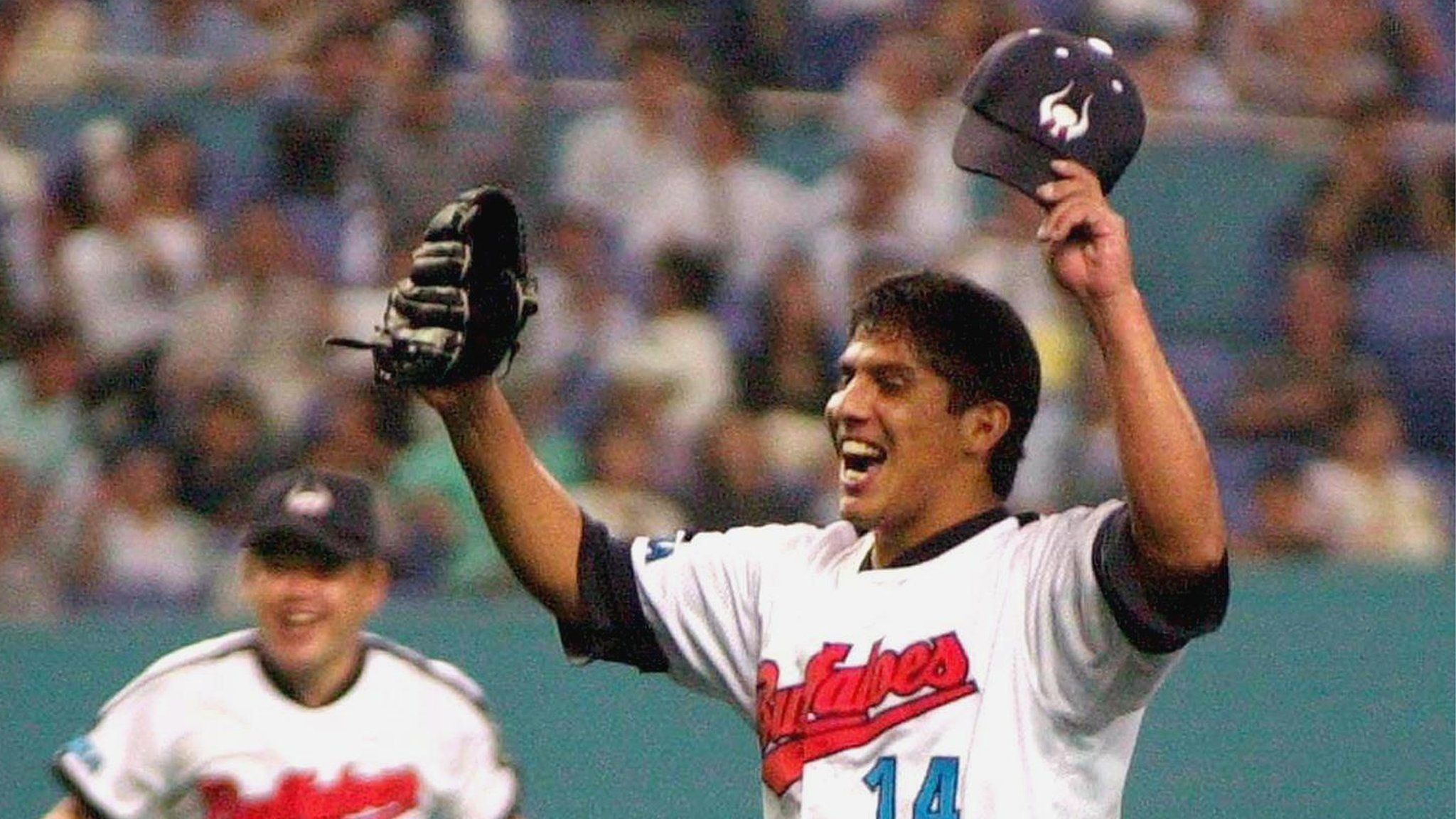Mexican pitcher Narciso Elvira of the Kintetsu Buffaloes throws his hands in the air to celebrate after he pitched a no-hit, no run game against the Seibu Lions during a Pacific League professional baseball game at the Osaka Dome, in western Japan 20 June 2000