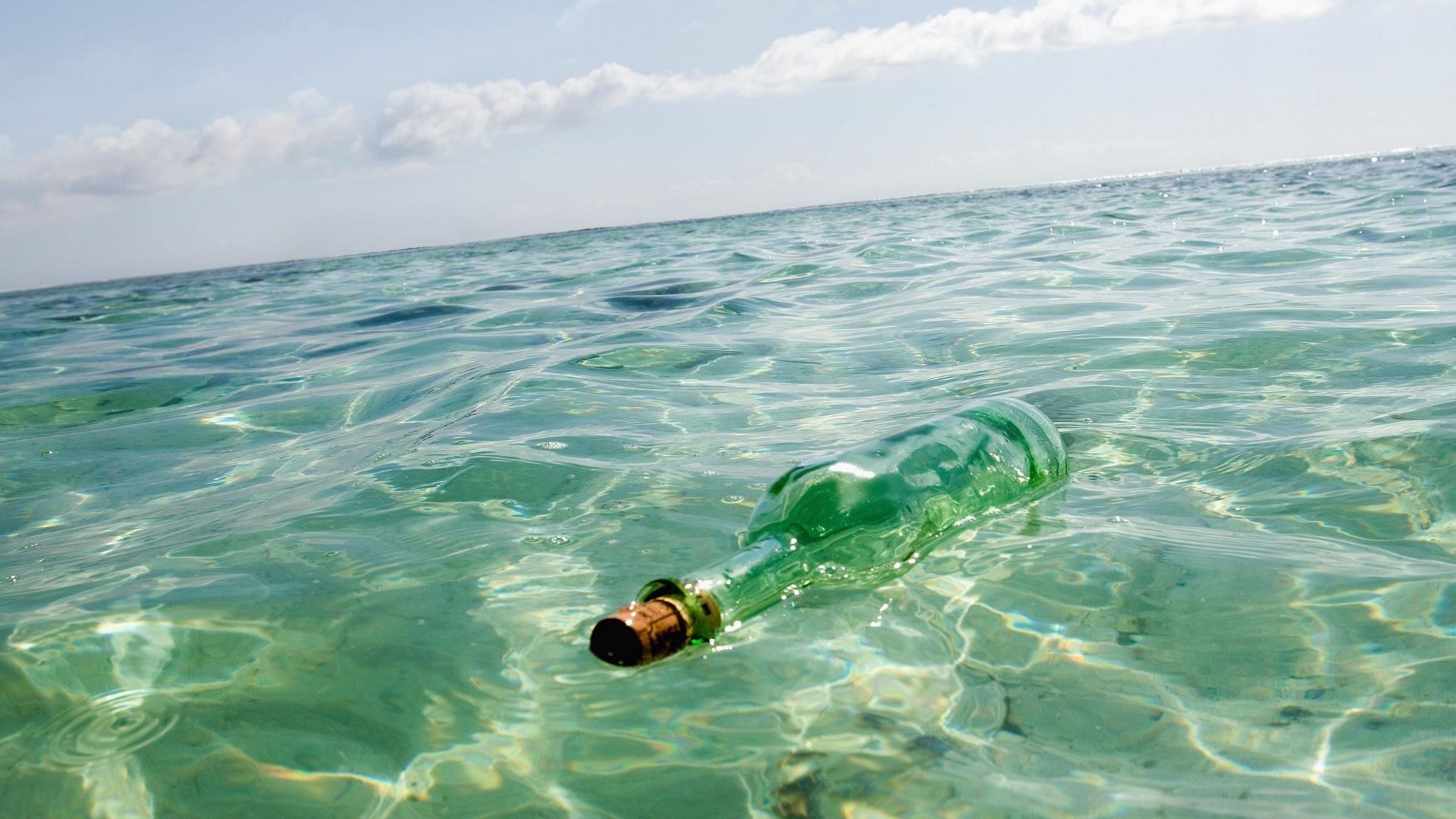 A glass bottle floating in the sea near La Digue Island in the Seychelles.