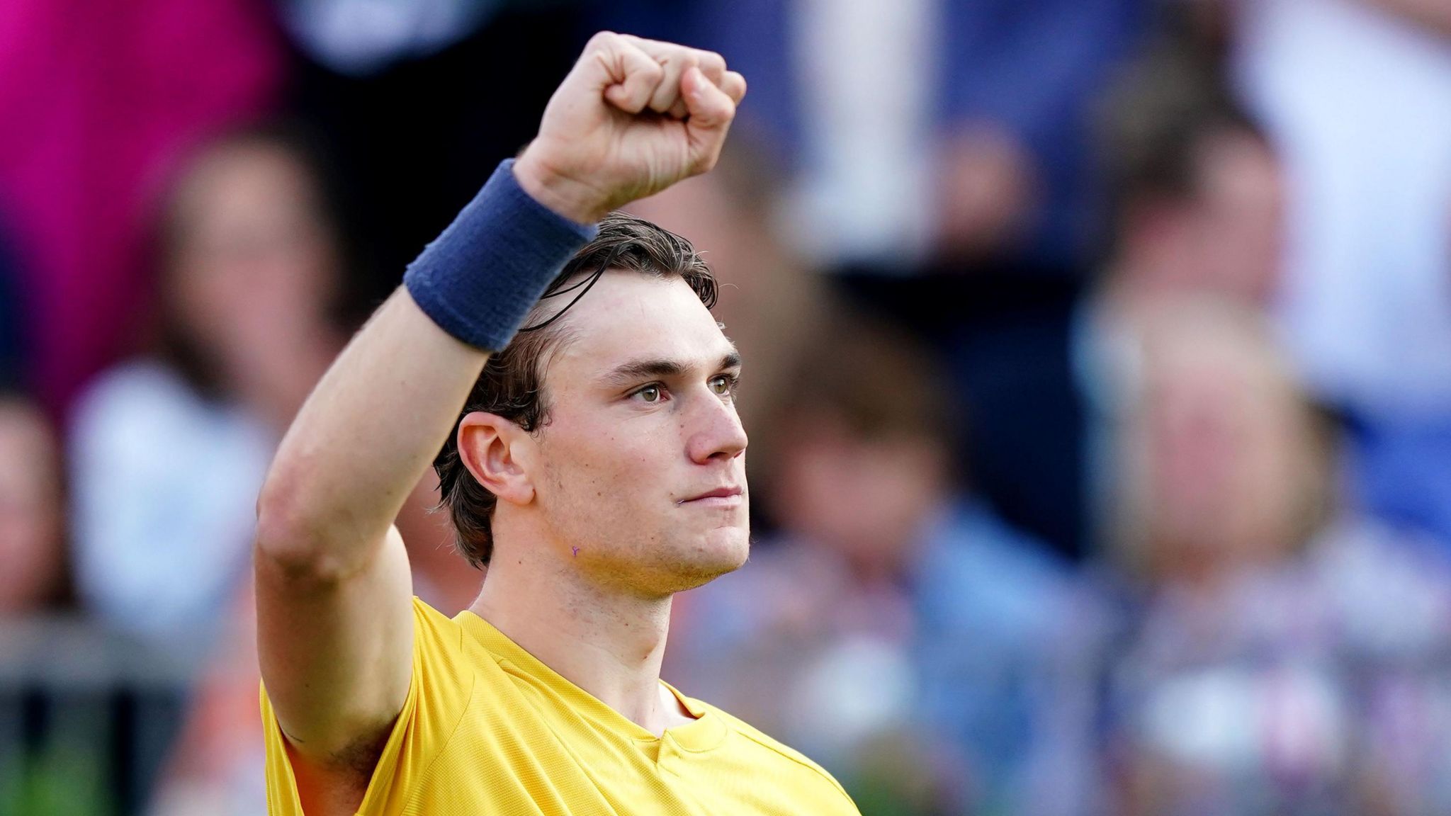 Jack Draper raises his fist in celebration at Queen's