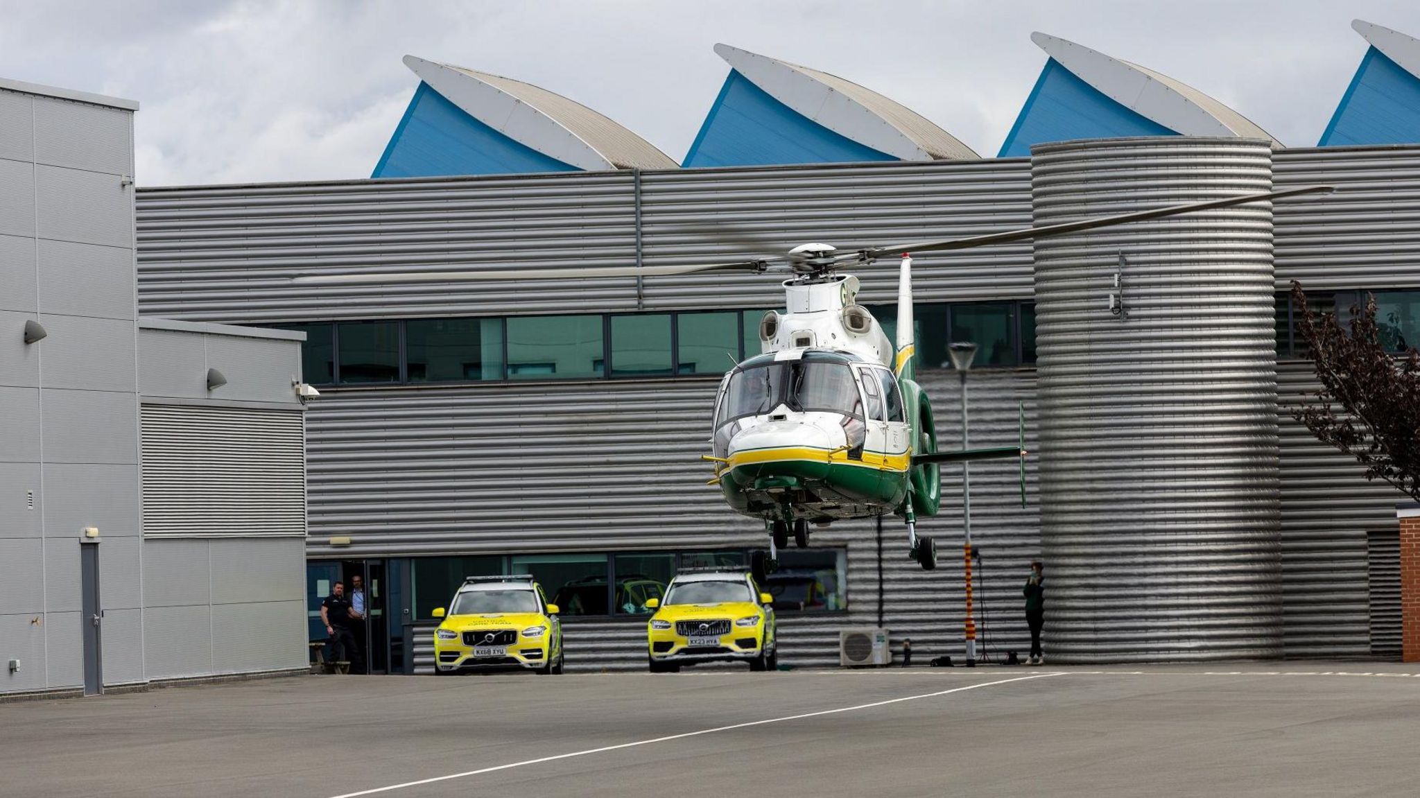 A GNAAS air ambulance taking off ahead of two rapid response vehicles