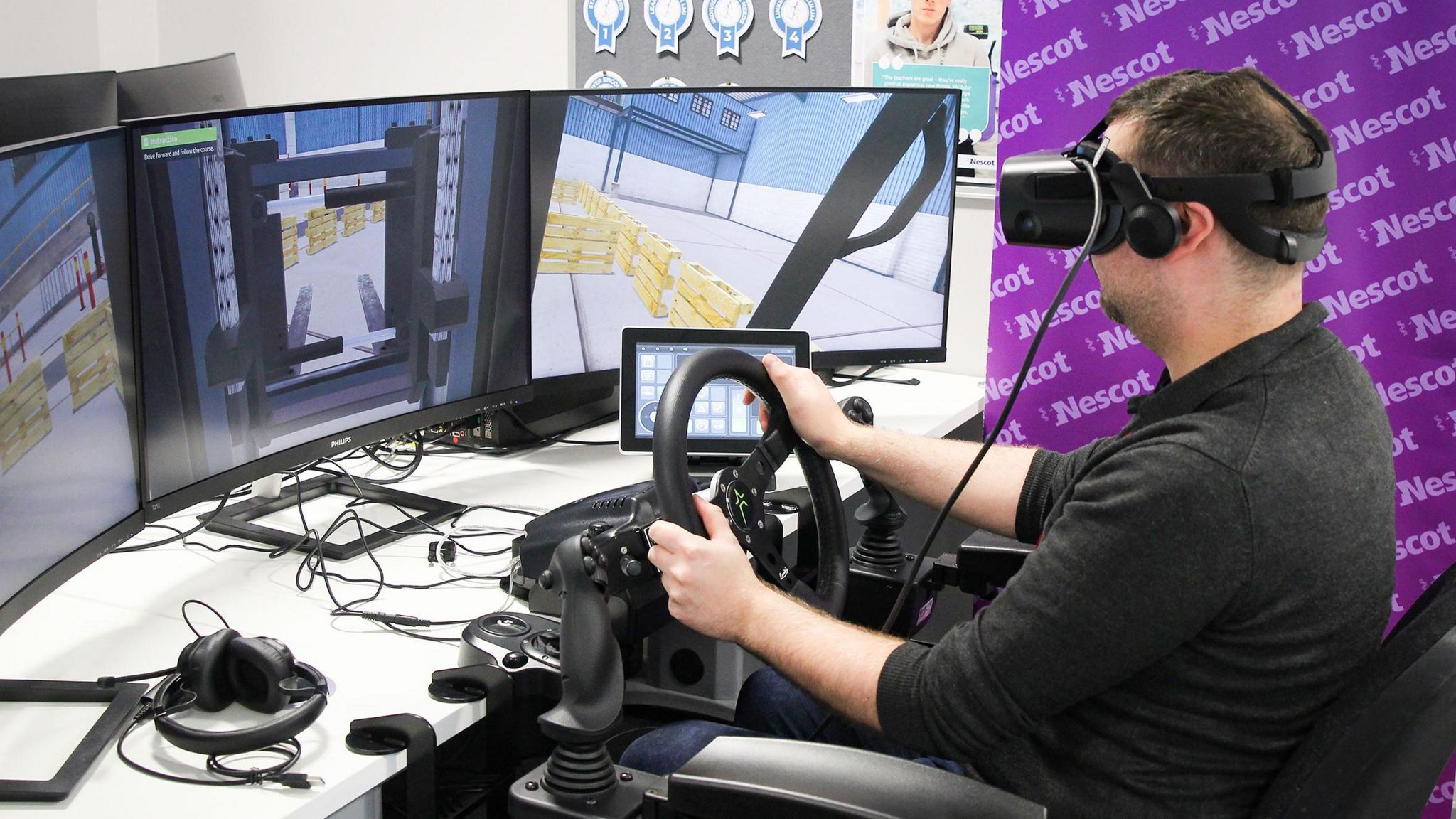 A person with a VR headset on driving a simulated forklift