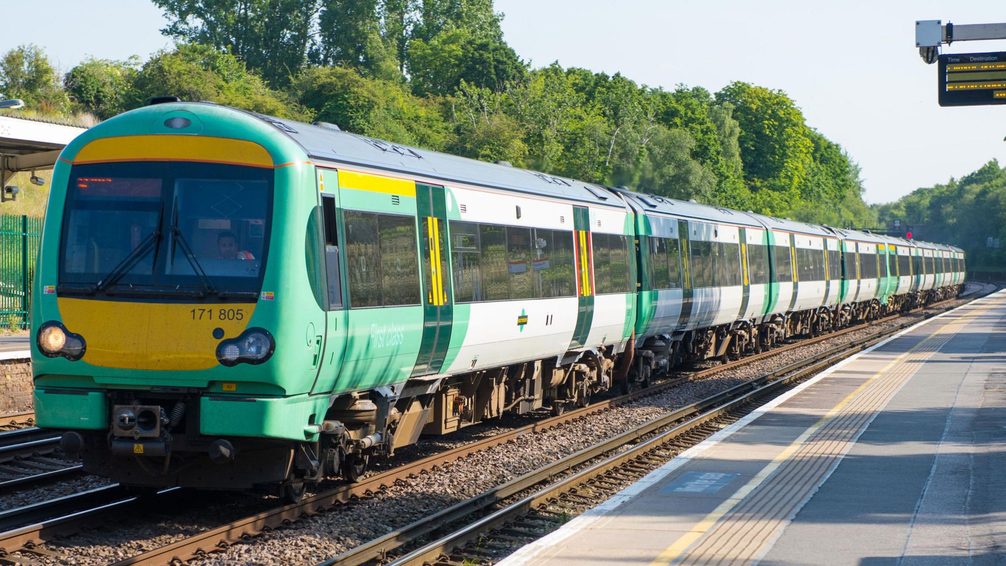 A Southern train passing through a station