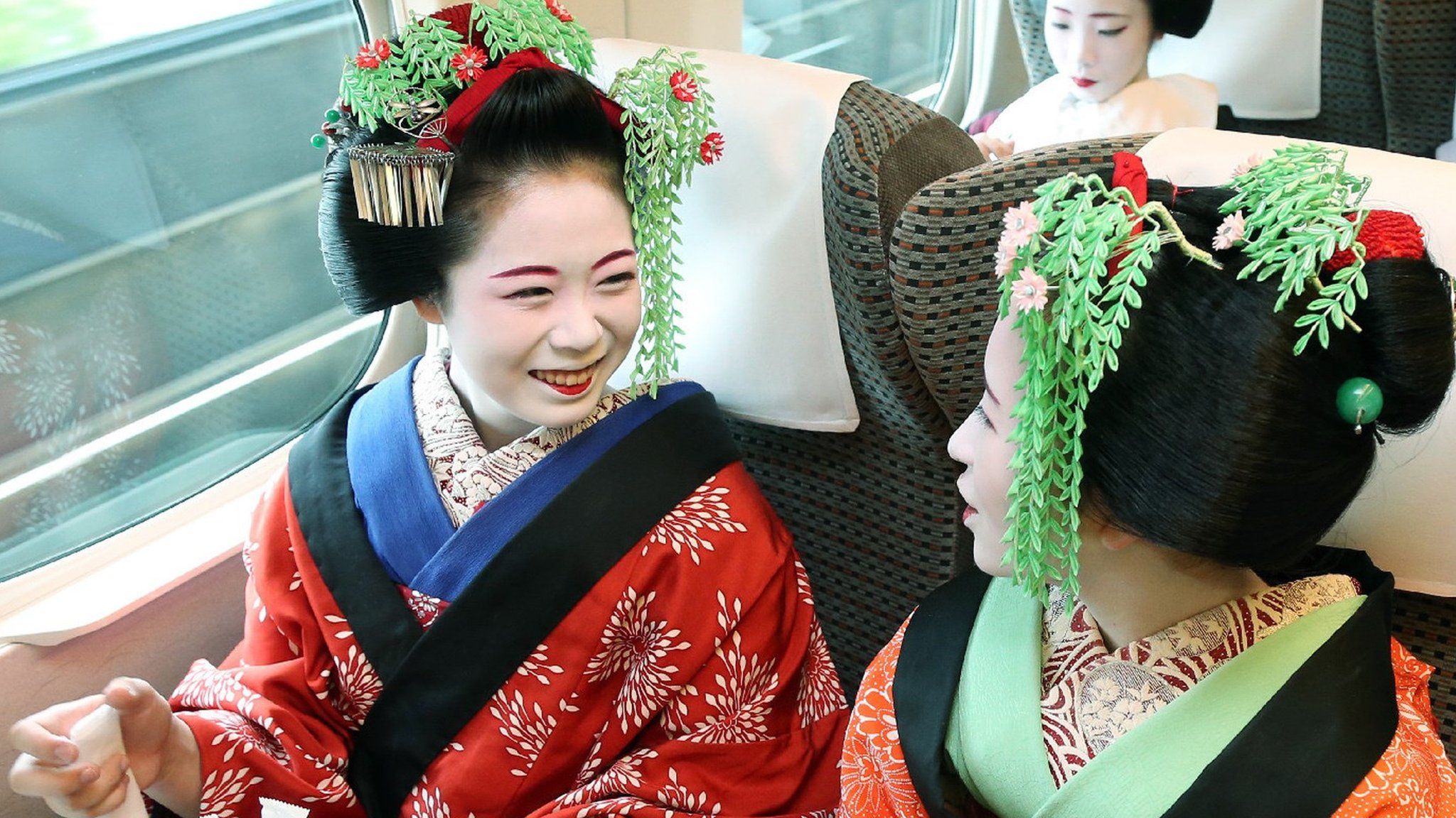 Geishas on a bullet train in Japan