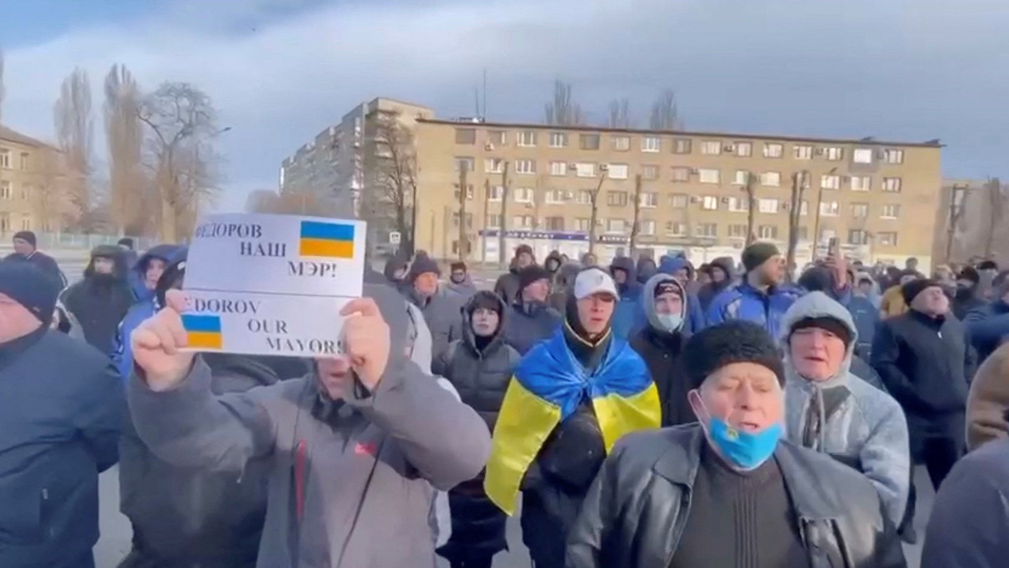 People protest the abduction of Mayor Ivan Federov, outside the Melitopol regional administration building, after he was reportedly taken away by Russian forces, during their ongoing invasion, in Melitopol, Ukraine in this still image obtained from handout video released March 12, 2022. Courtesy of Deputy Head for President