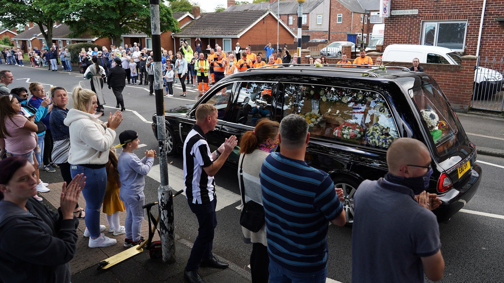 People line the streets as the funeral cortege of Jack Charlton passes through his hometown of Ashington