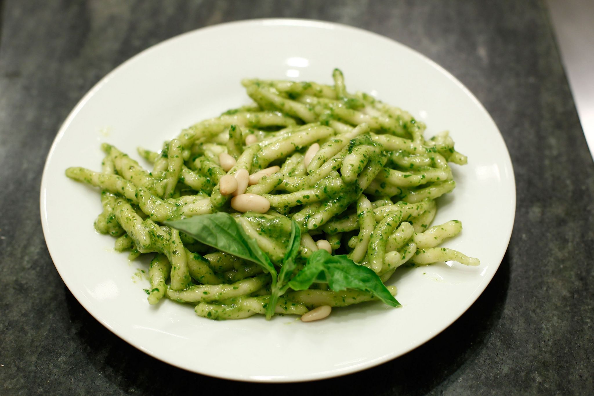 A plate of pasta with pesto