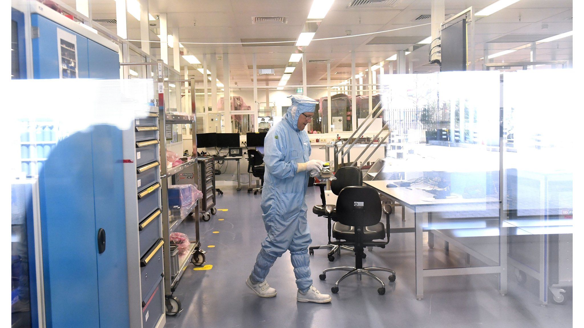 ASML technician working in the plant in Veldhoven wearing protective clothing