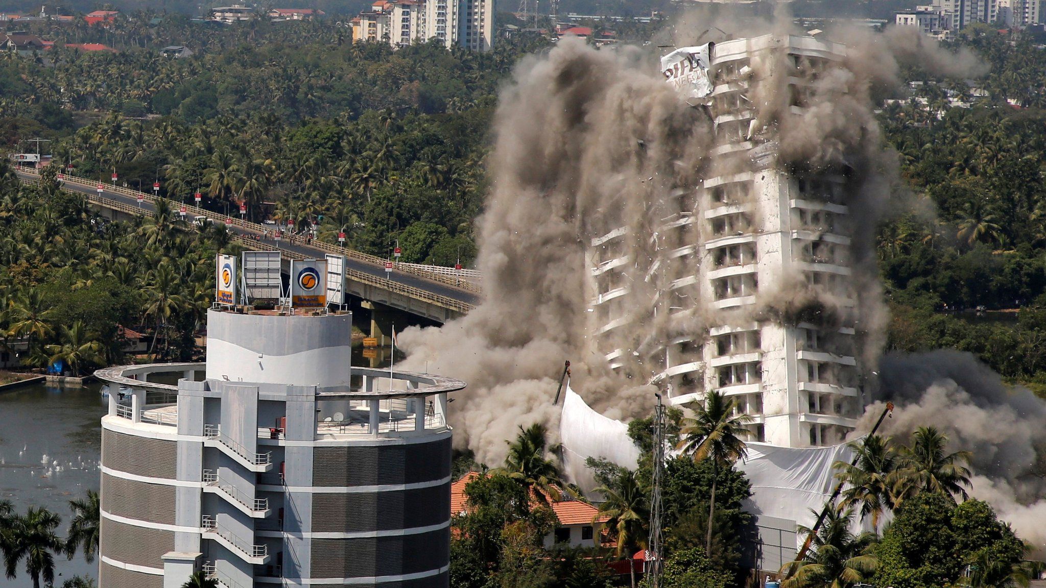 A high-rise residential building is demolished with controlled blasting in Kochi, India, 11 January, 2020.