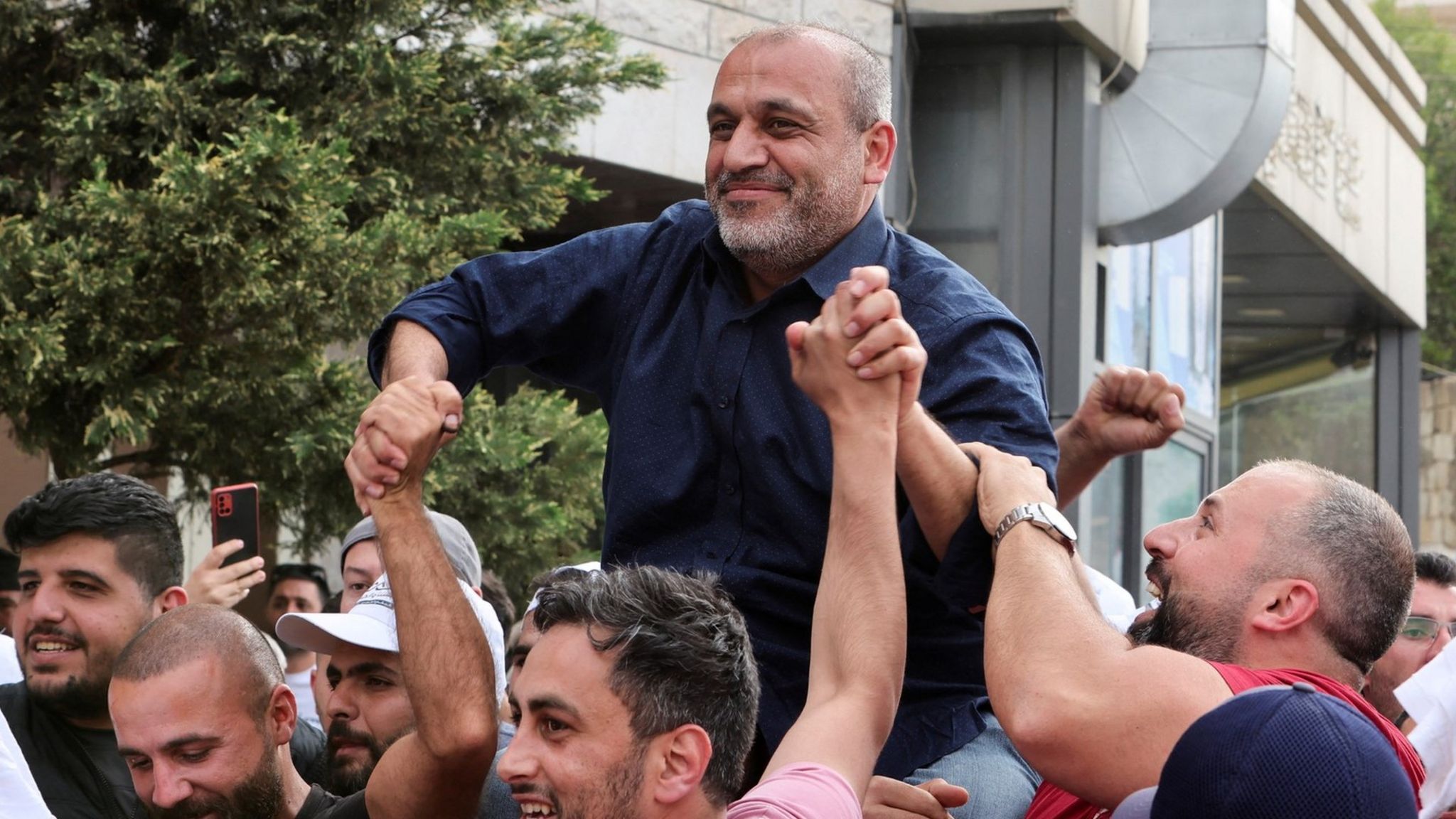 Opposition candidate Yassin Yassin is greeted by his supporters in Jeb Jennin, West Bekaa, Lebanon (16 May 2022)