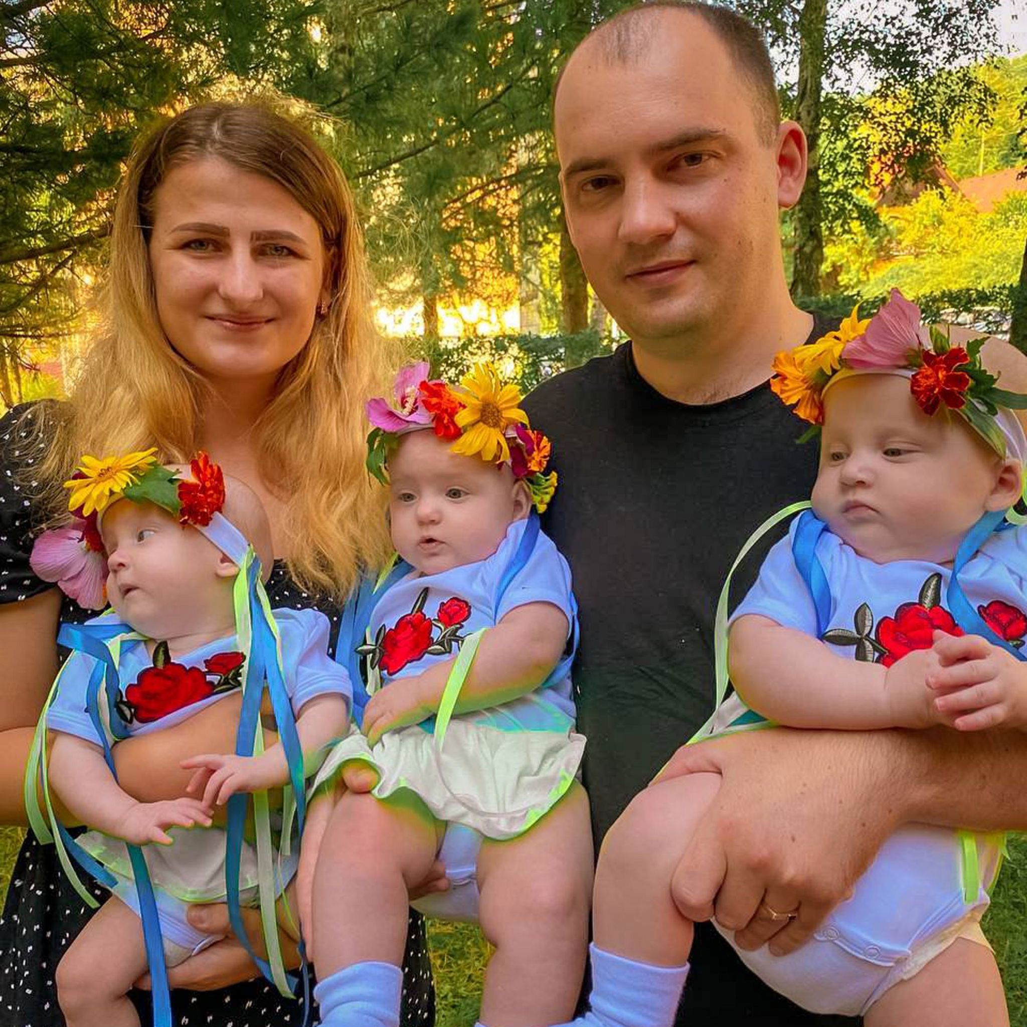 Hanna and Andriy holding their three daughters