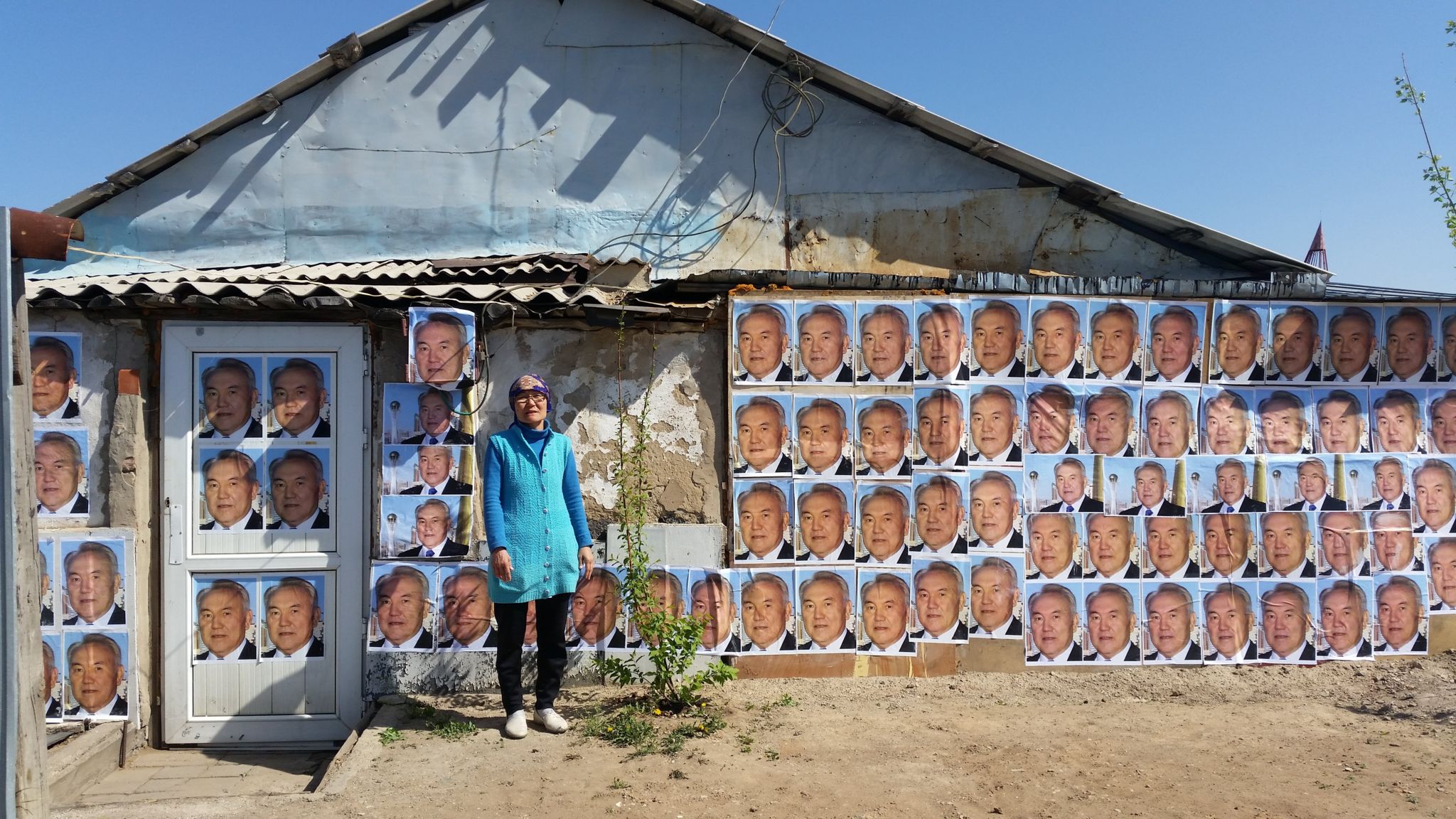 A woman in Astana, Kazakhstan has plastered the outside walls of her house with images of President Nursultan Nazarbayev to stop it from being demolished