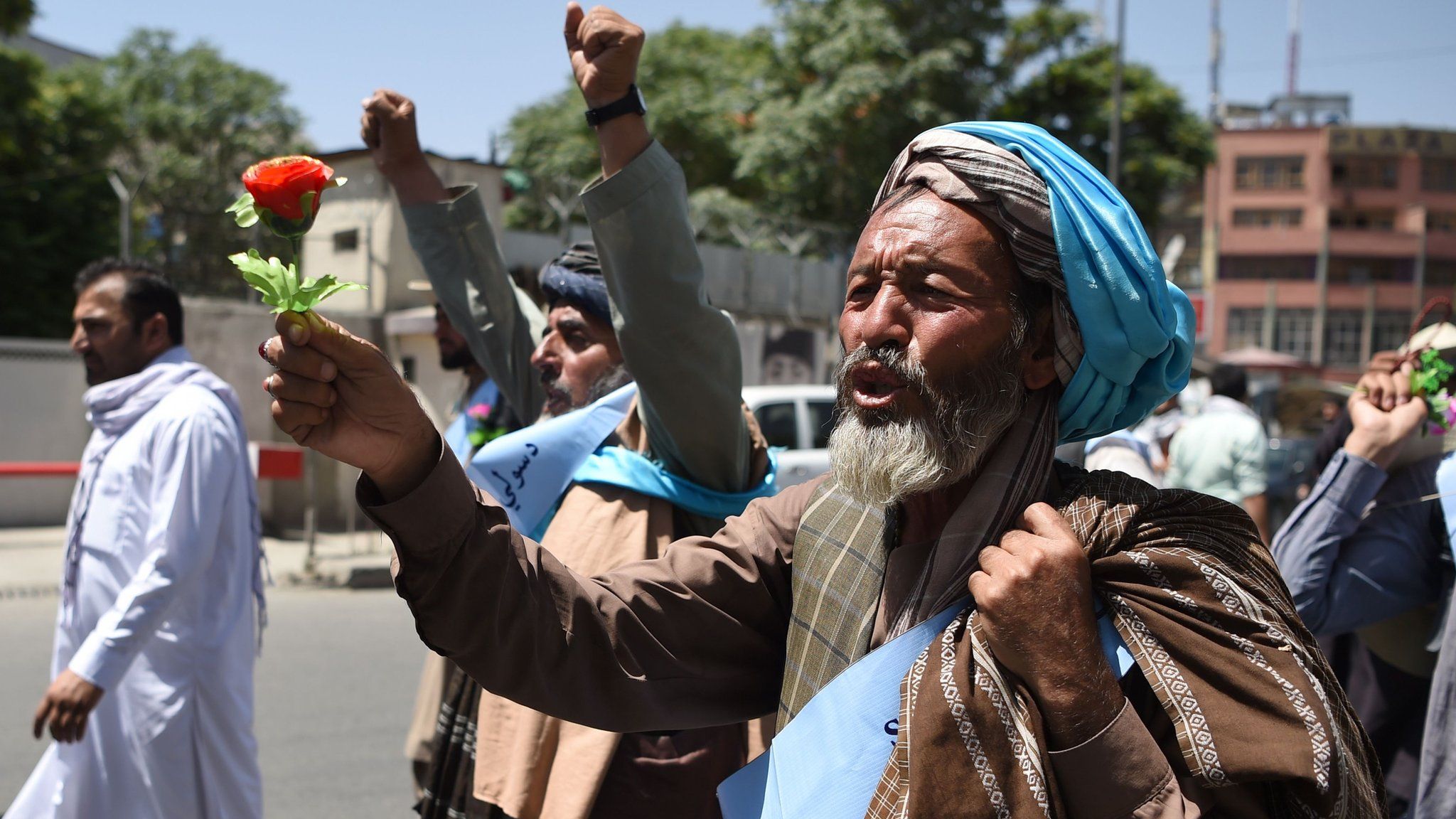 An Afghan peace activist shouts slogans in demand to an end to the war during a march from Helmand as he arrives in Kabul on June 18, 2018