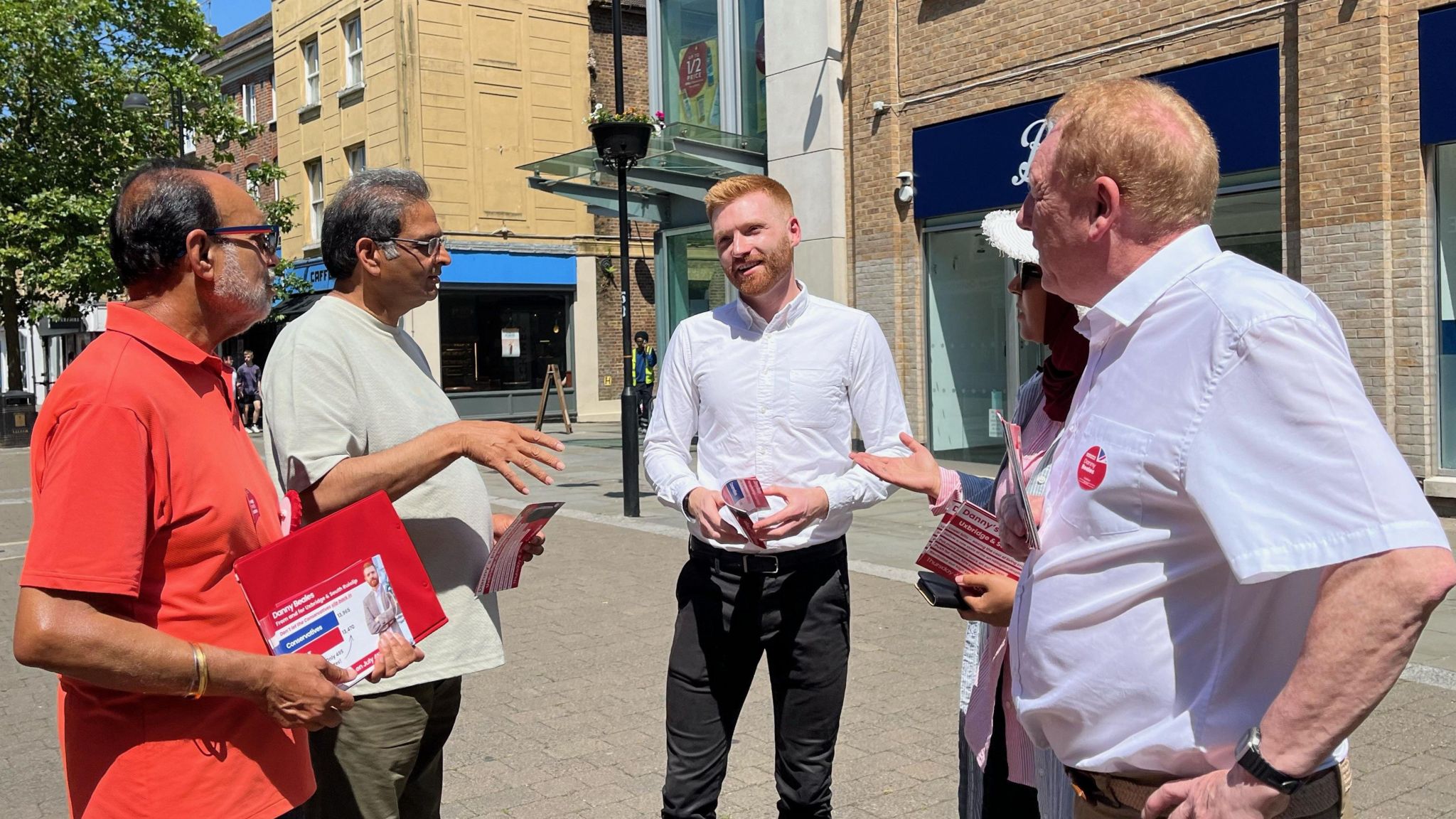 Danny Beales, centre, talking to four canvassers on a high street