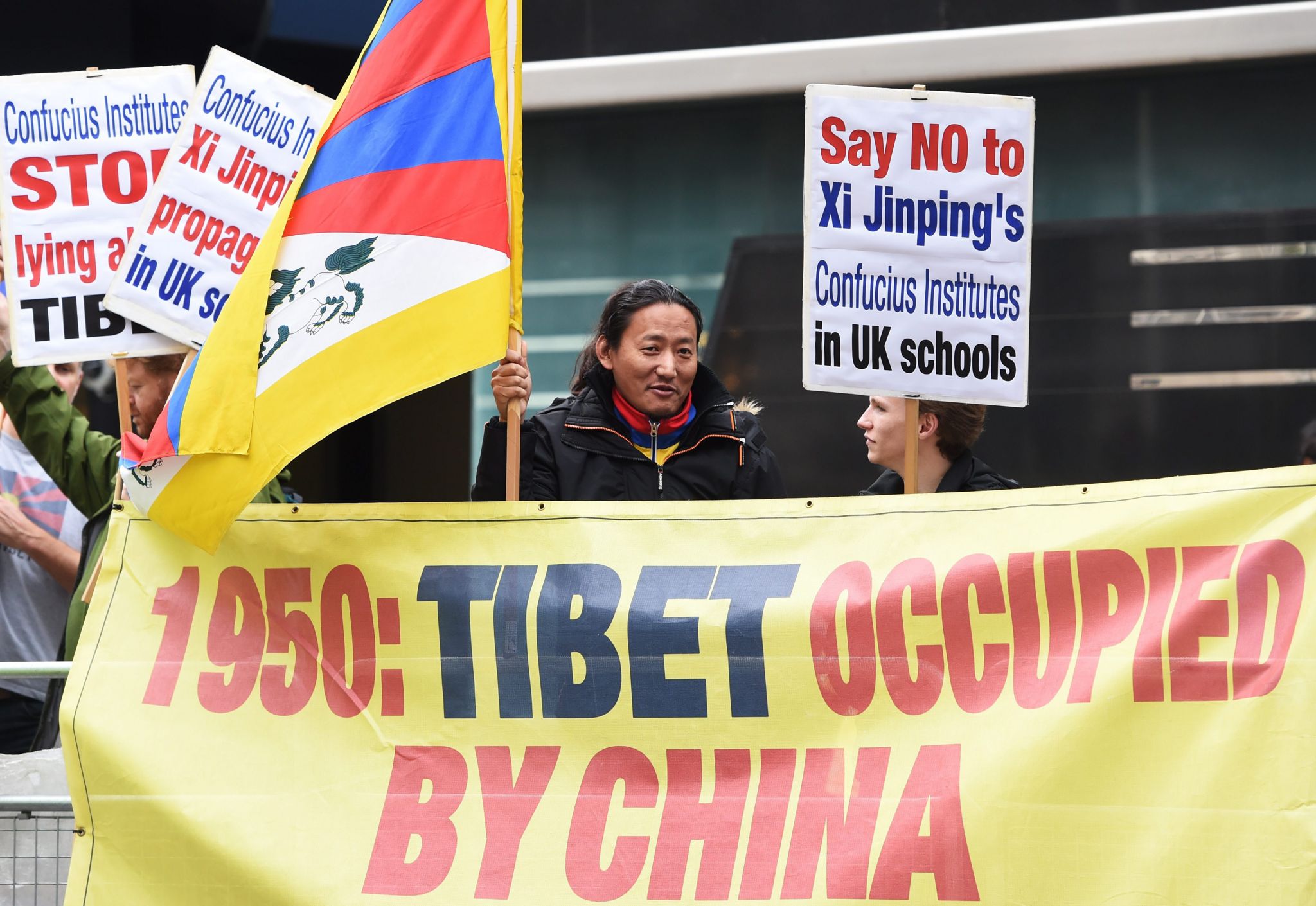 Free Tibet demonstrators hold banners outside the Mandarin Hotel where the conference is being held