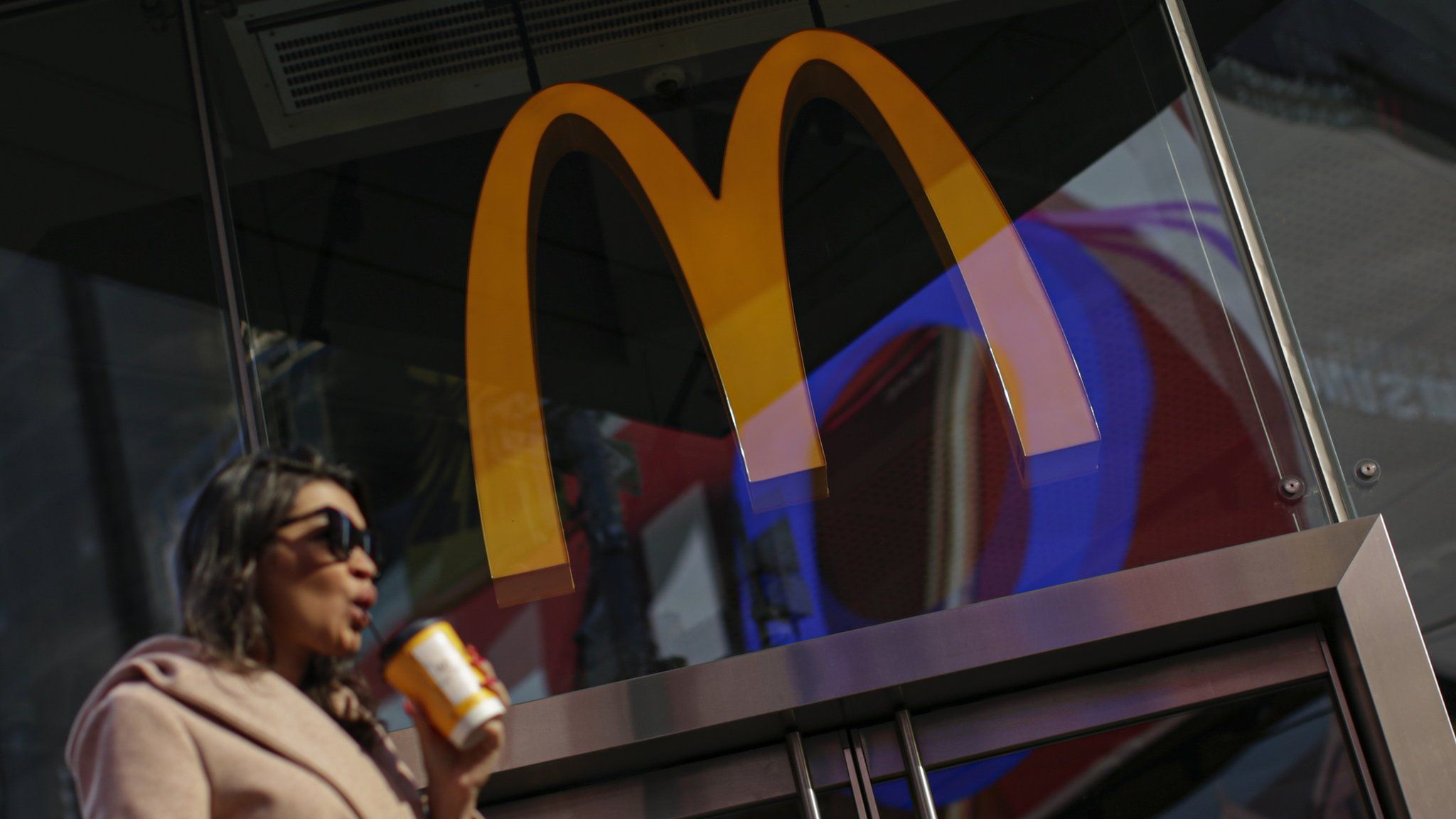 A woman walk pass McDonald's restaurant in Times Square following the firing of their CEO, Steve Easterbrook on November 4, 2019 in New York City
