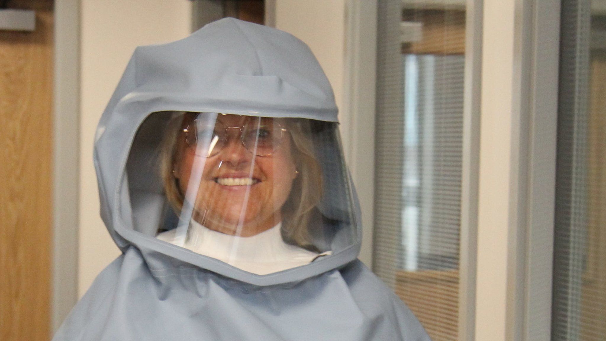 Matron Sally Young wearing the new full-face protective hood