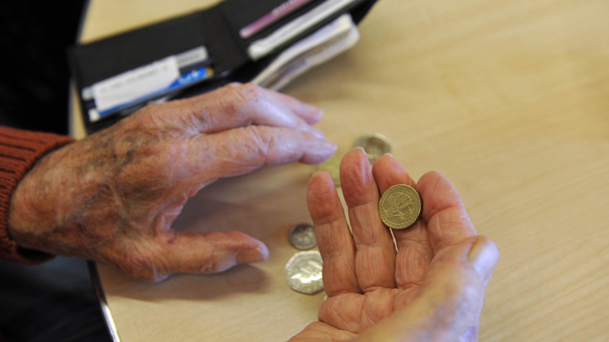 Elderly person holding money