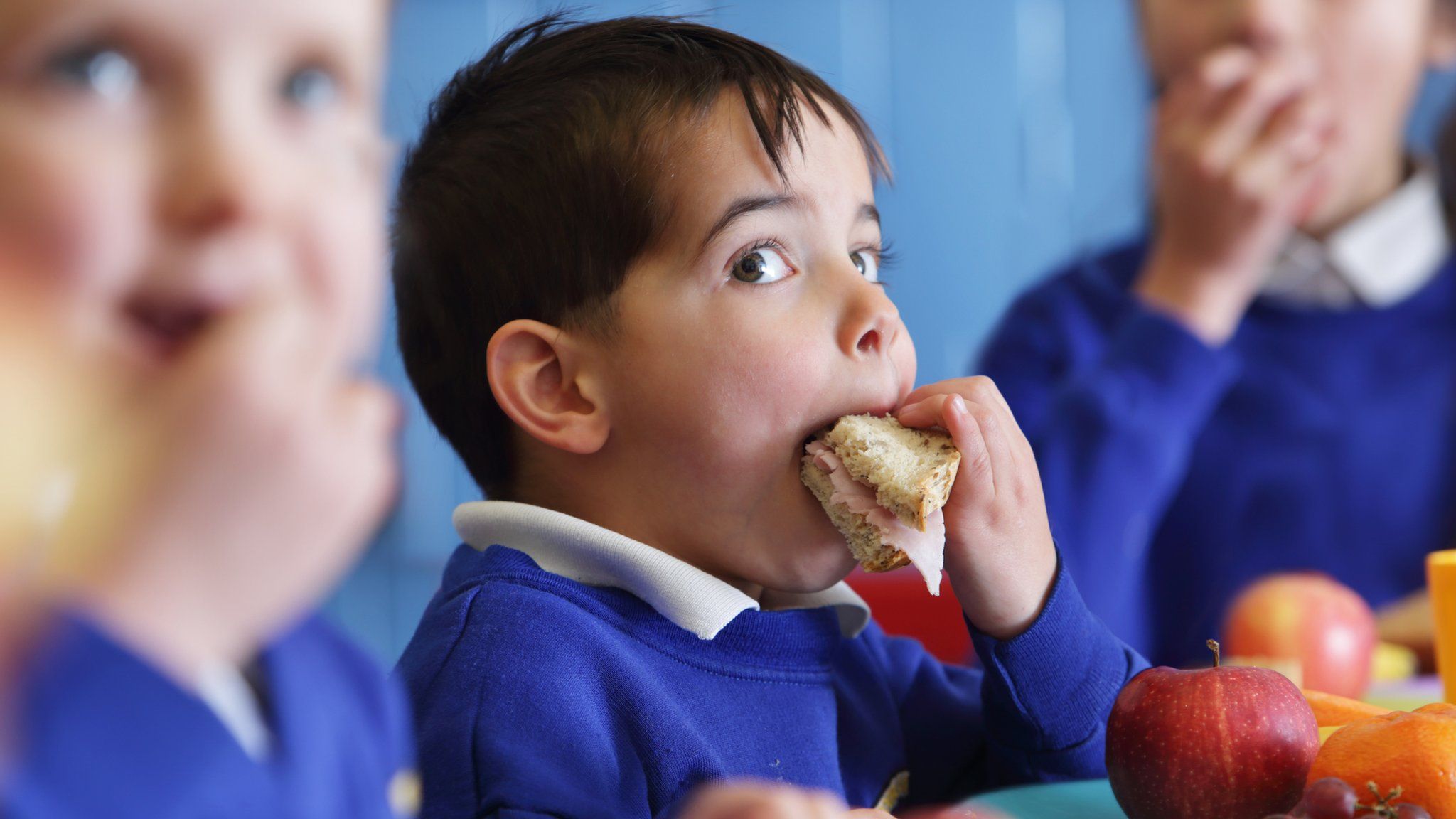 child eating sandwich