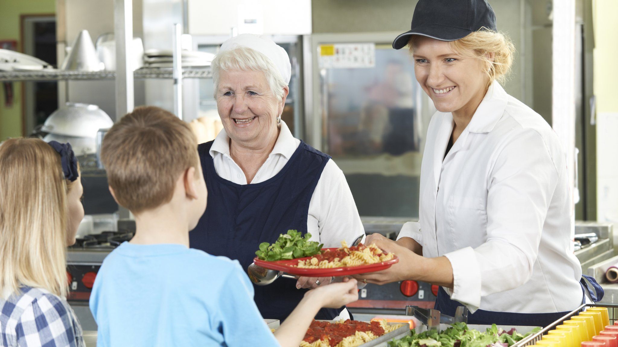 Children being handed school lunches