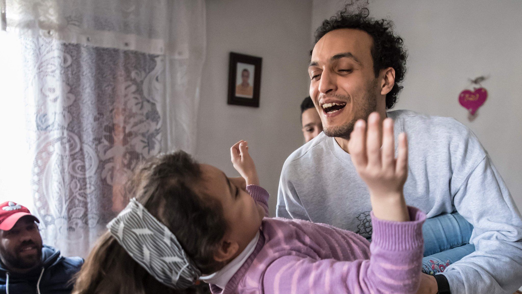 Egyptian photojournalist Mahmoud Abou Zeid, widely known as Shawkan, plays with his niece at his home in Cairo on 4 March 2019