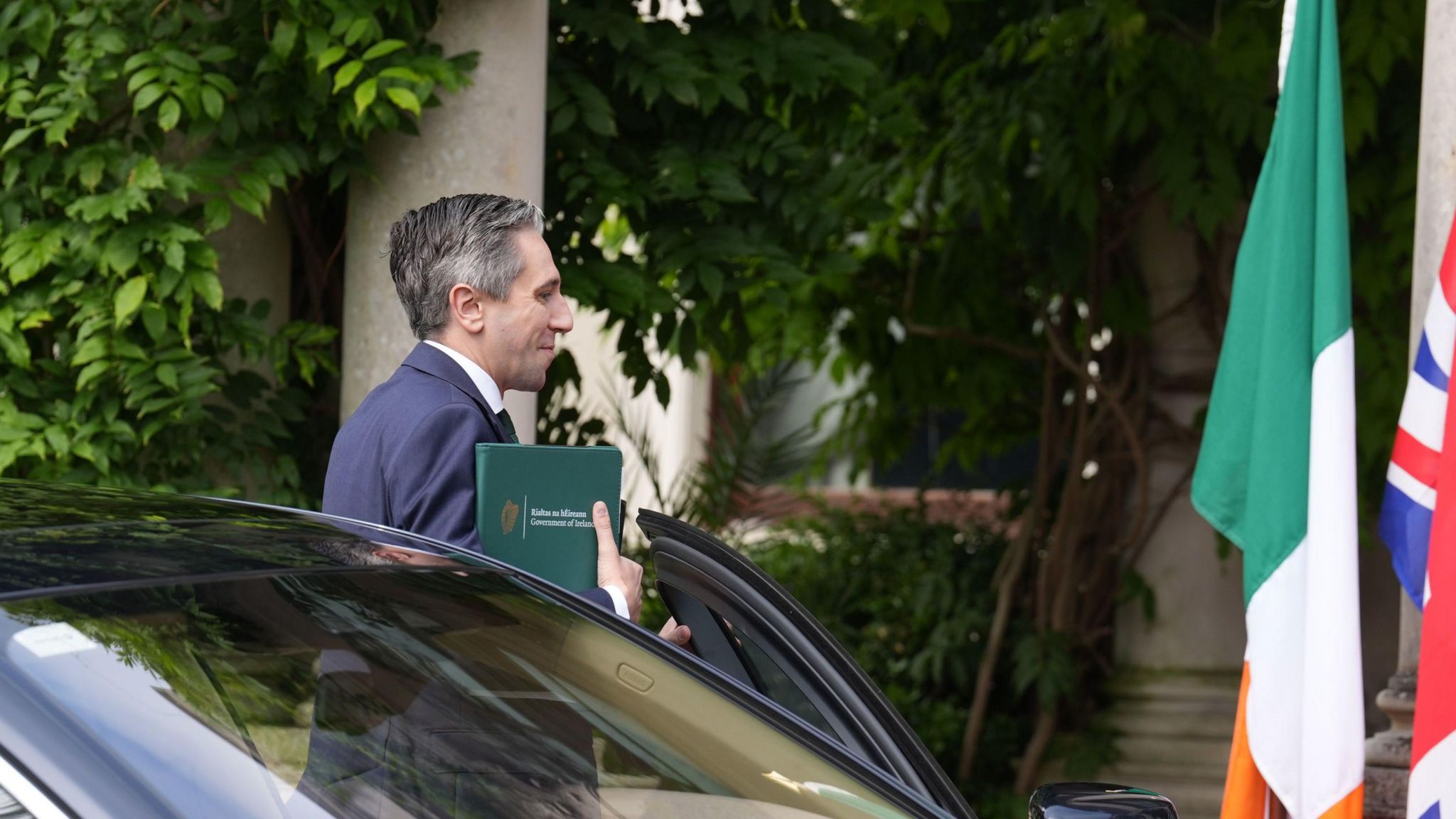 Taoiseach Simon Harris getting out of a car outside Farmleigh House. 