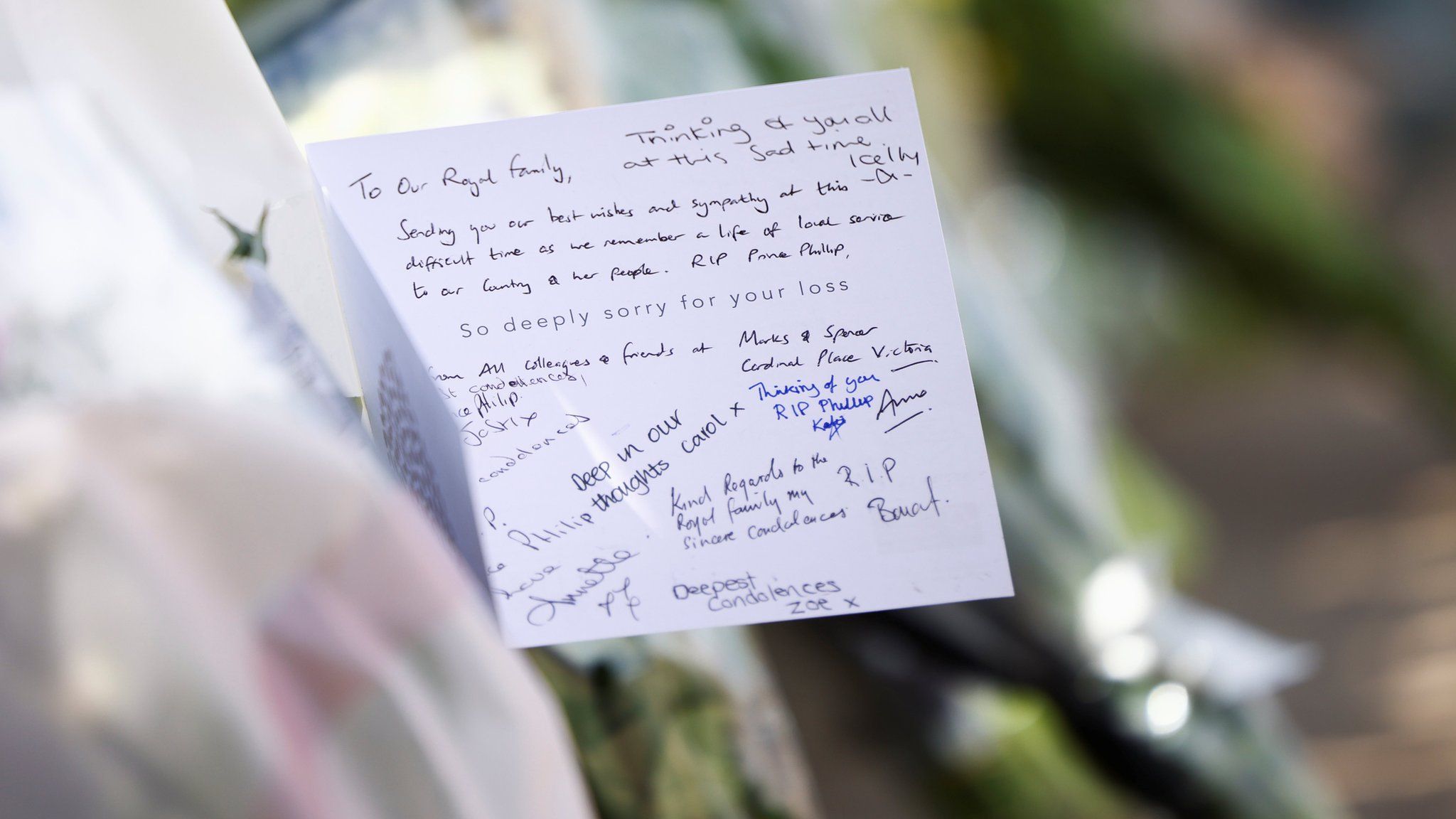A sympathy card attached to flowers outside Buckingham Palace on 9 April 2021
