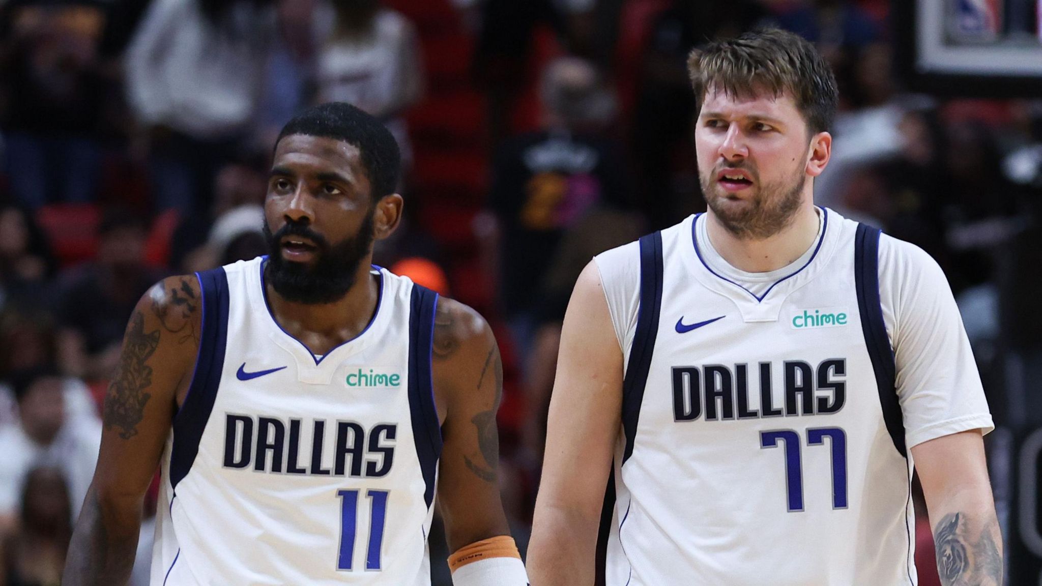 Kyrie Irving stands next to Luka Doncic