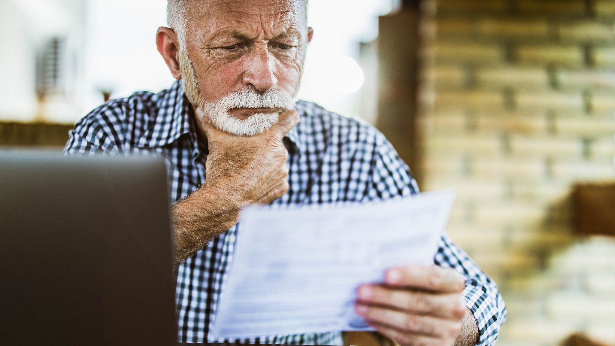A man looks through financial paperwork
