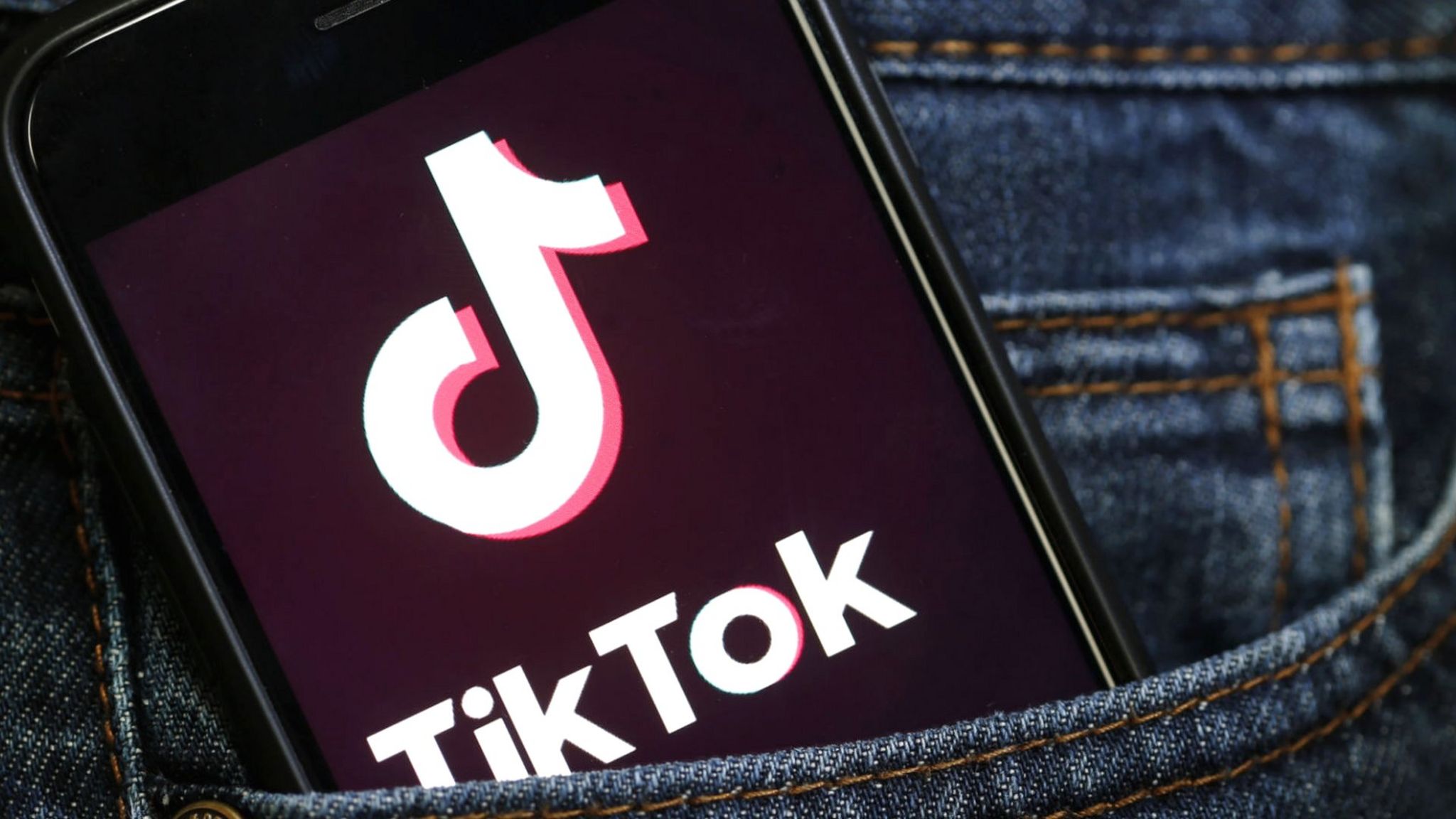TikTok's logo is displayed on a phone.