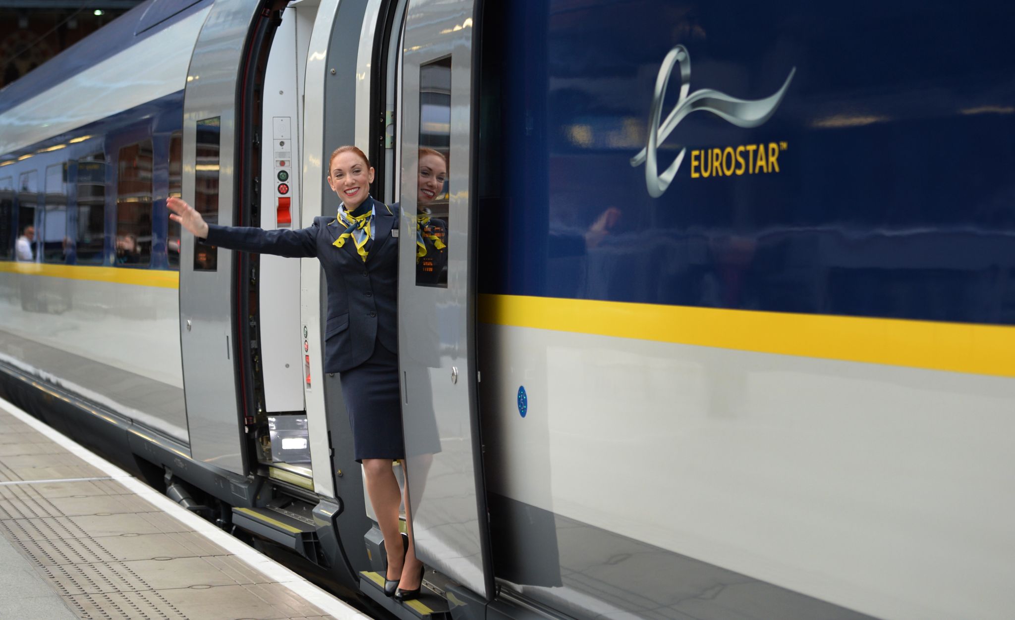 A Eurostar staff member waving from the new e320 train