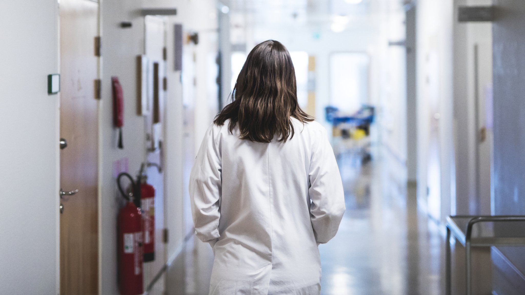 A doctor walking on a hospital corridor