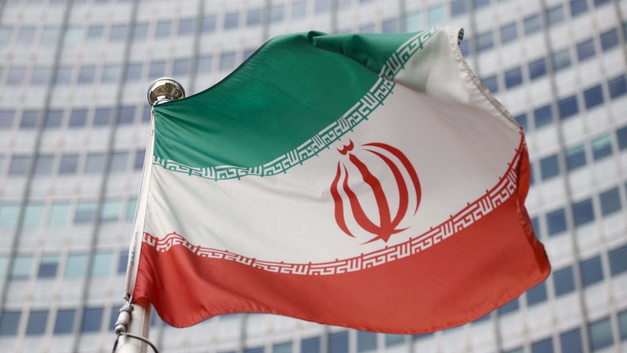 File photo showing flag of Iran flying in front of the headquarters of the International Atomic Energy Agency in Vienna, Austria