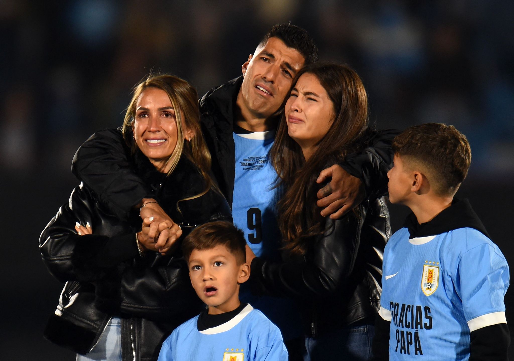 An emotional Luis Suarez on the pitch with his family watching some pre-match tributes