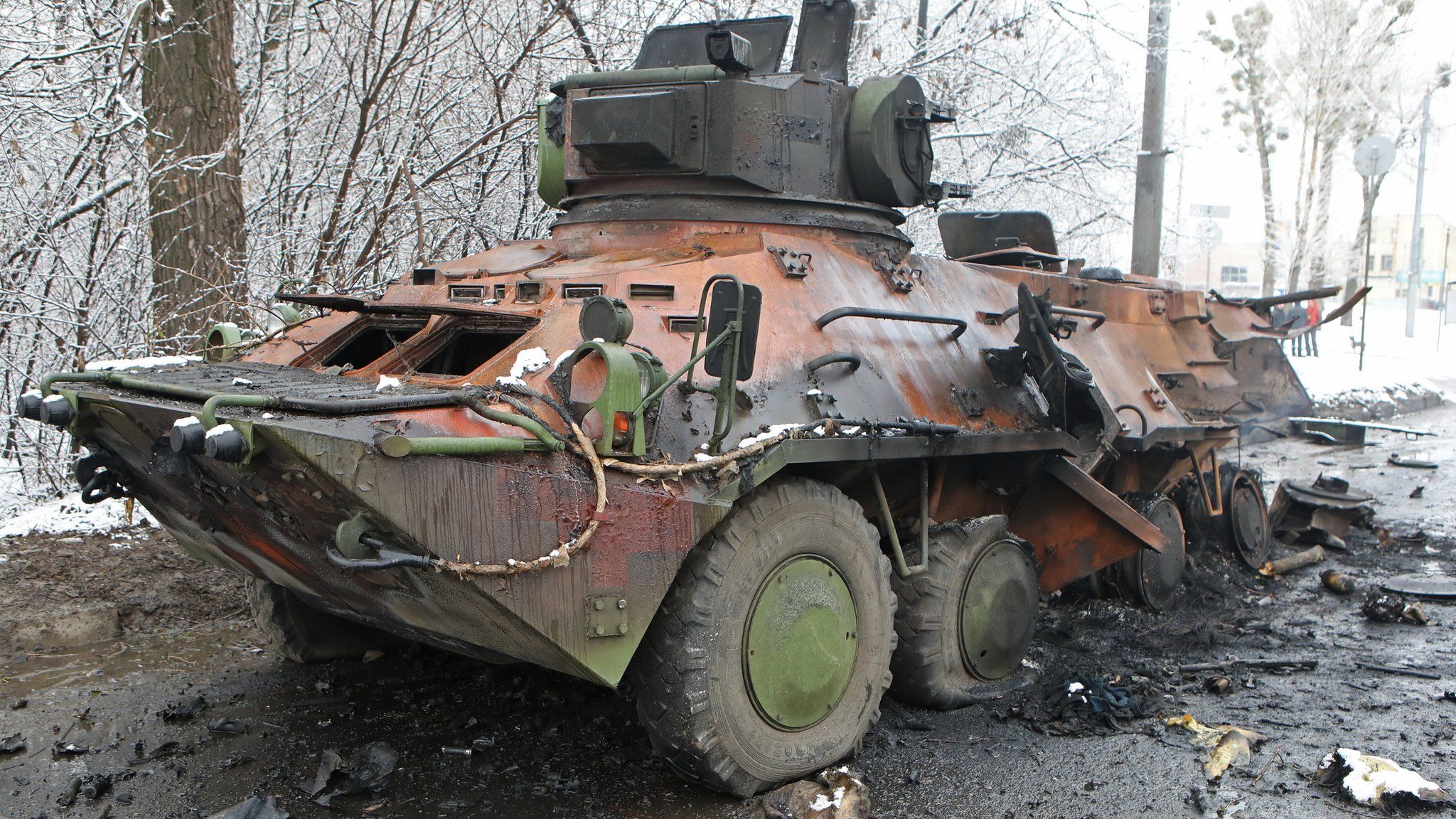 A view shows a destroyed armored personnel carrier on the roadside in Kharkiv
