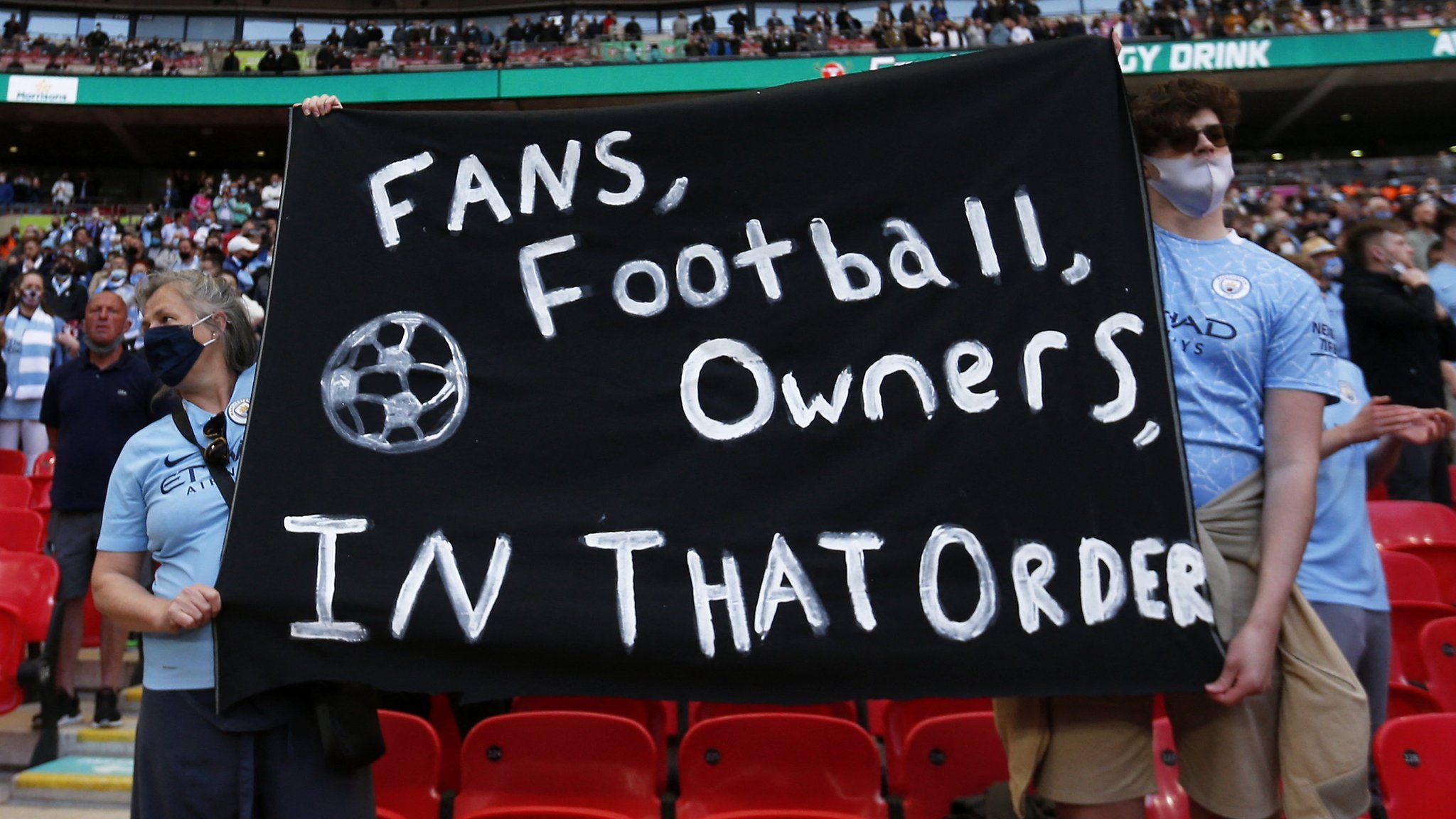 Fans hold banner