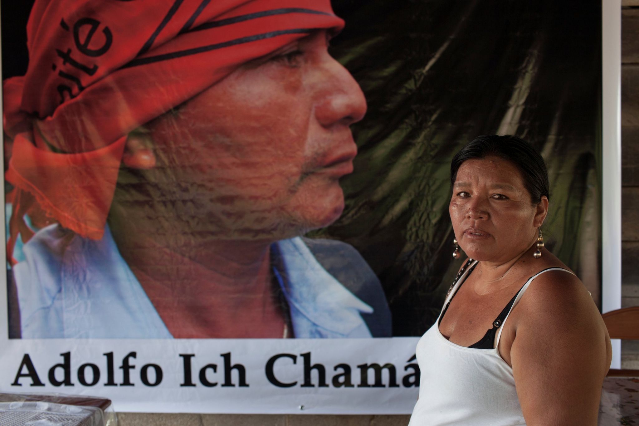 Angelica Choc stands in front of a banner with an image of her slain husband, former Q'eqchi' Mayan community leader, teacher and anti-mining activist Adolfo Ich