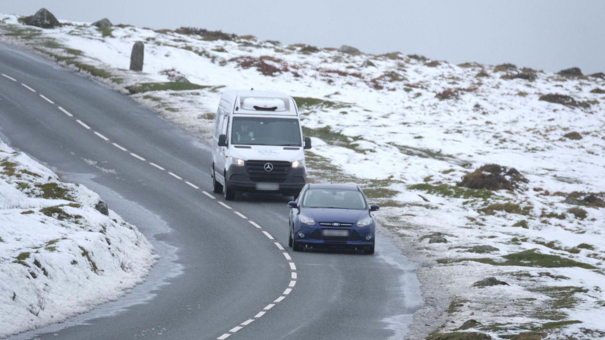 A car and van on a Dartmoor road