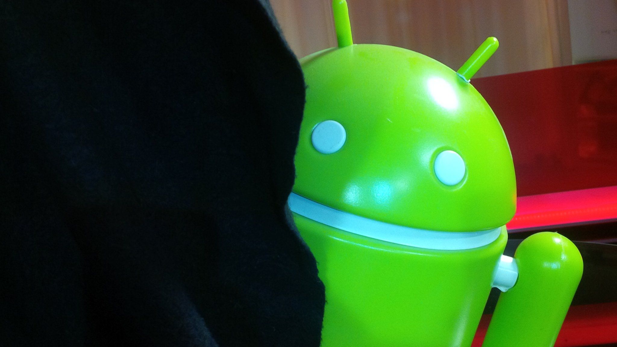 Android mascot behind a curtain