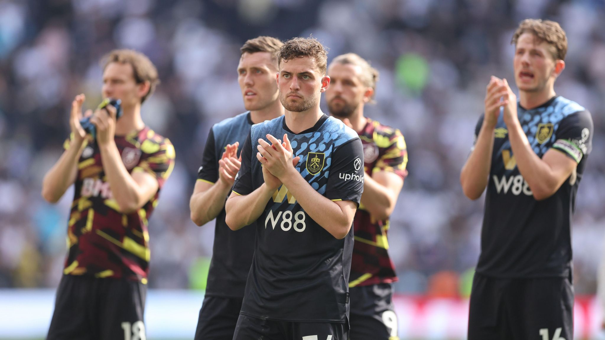 Dejected Burnley players applaud their fans after relegation was confirmed at Spurs