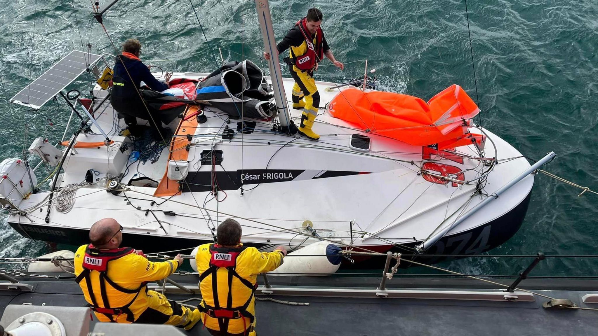 The RNLI crew helping the sailor on the yacht