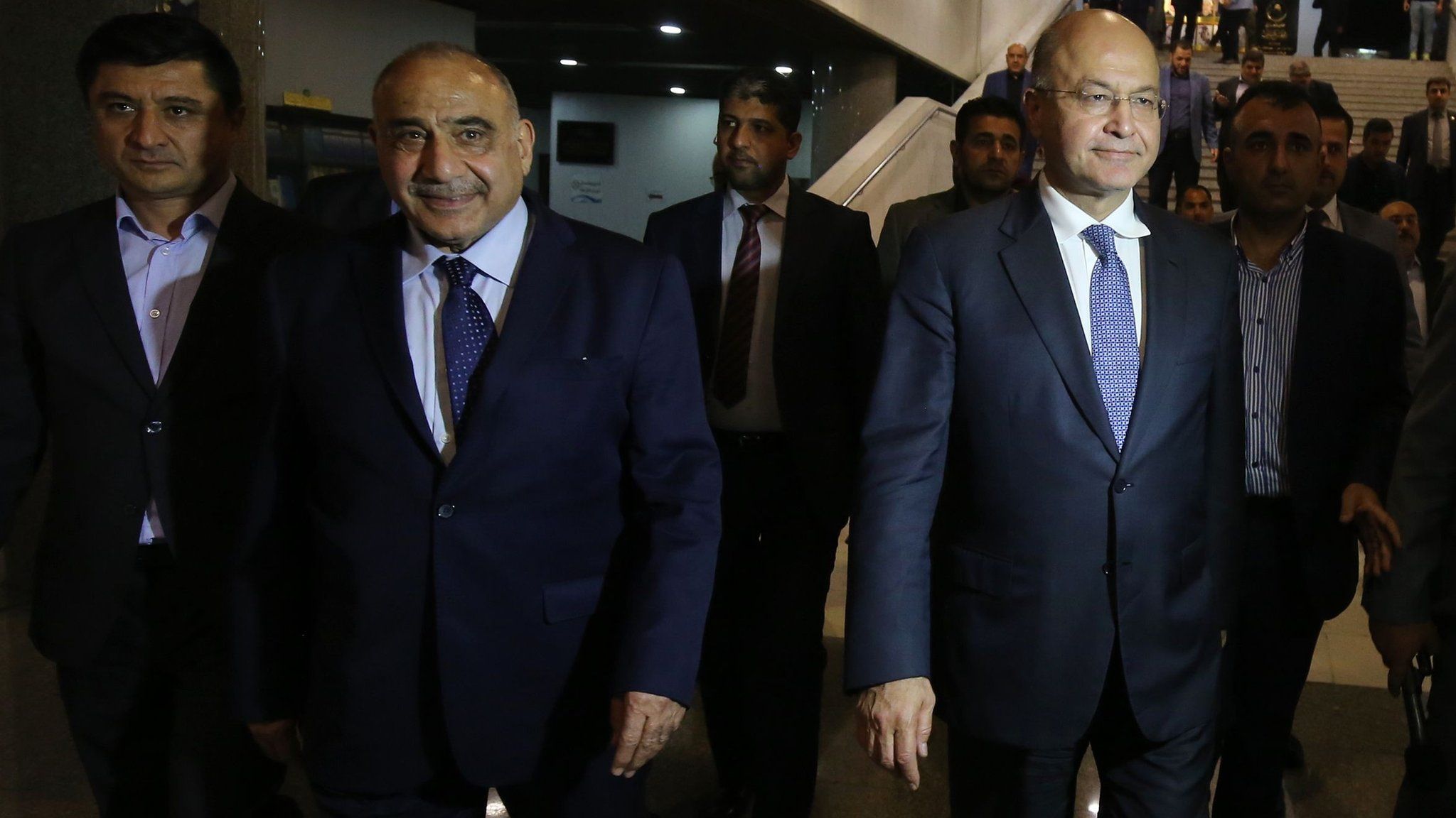 Iraq's Prime Minister-designate Adel Abdul Mahdi (2nd Left) and Barham Saleh (2nd Right) walk out of the Iraqi parliament on 2 October 2018